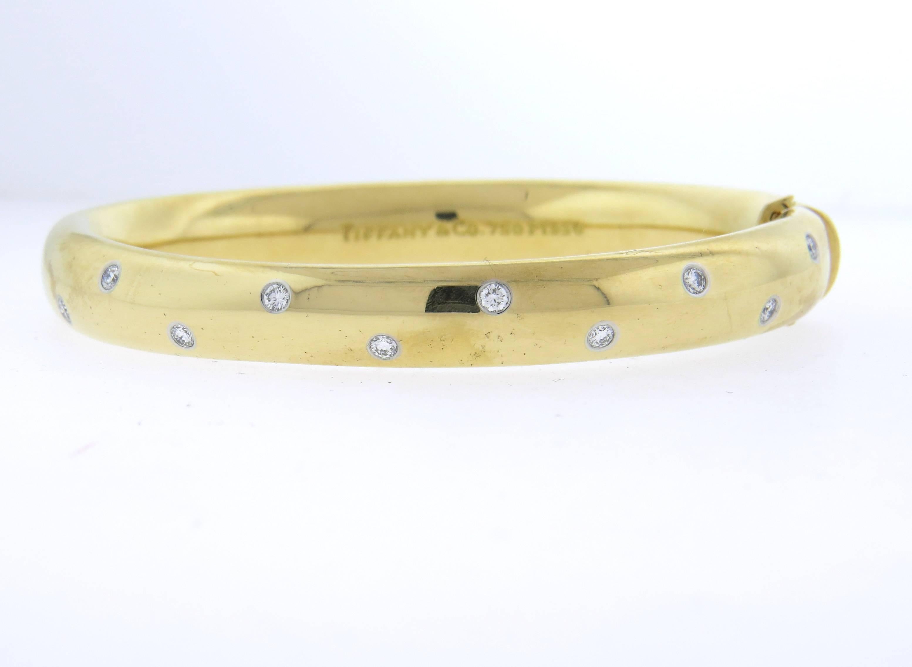 18k yellow gold and platinum bangle, crafted by Tiffany & Co for Etoile collection, decorated with approximately 0.50ctw in G/VS diamonds. Bracelet will comfortably fit up to 7