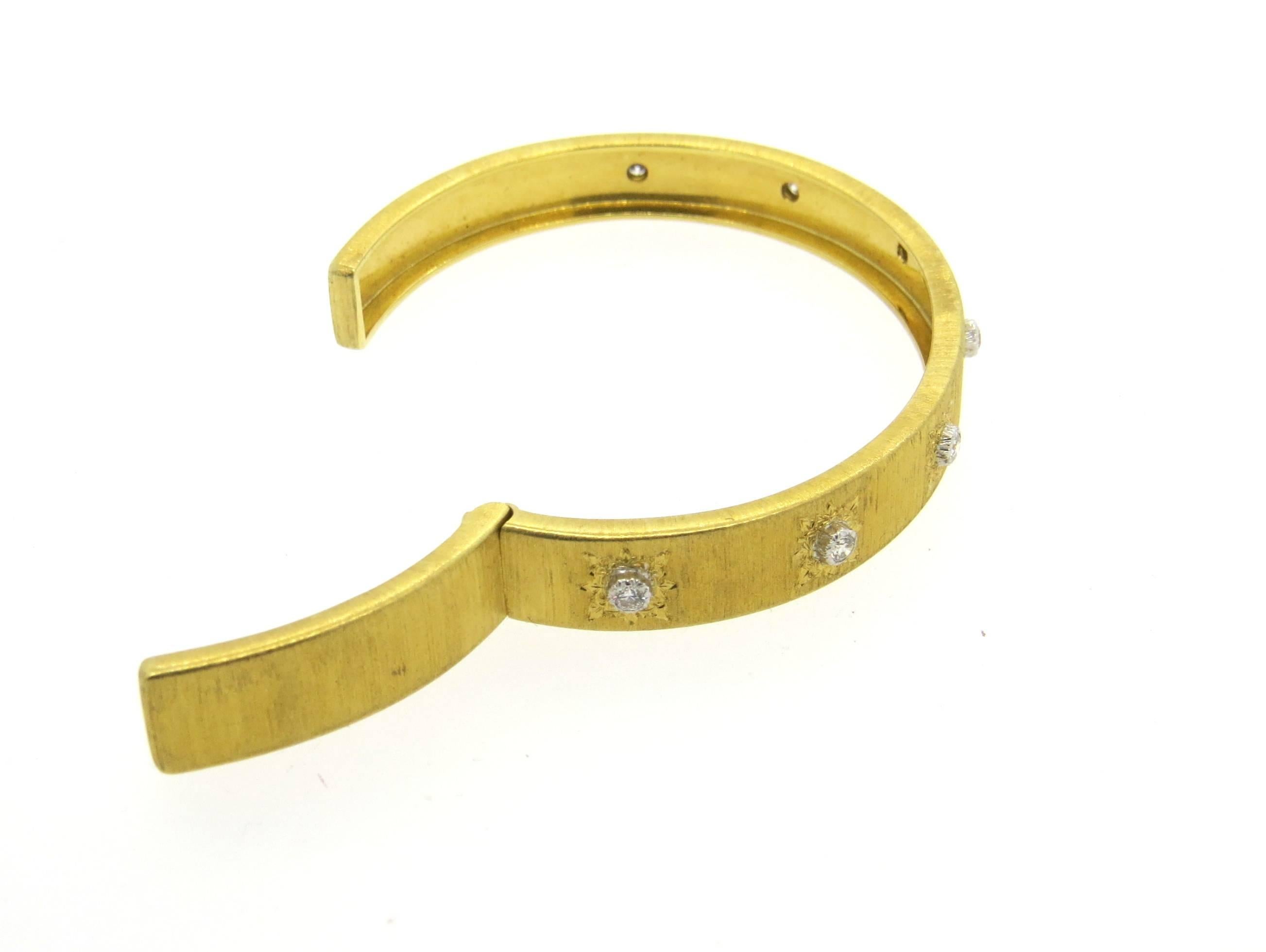 18k yellow gold classic cuff bracelet with hinge closure,  crafted by Buccellati, decorated with approximately 0.35ctw in H/VS diamonds. Bracelet will comfortably fit up to 7