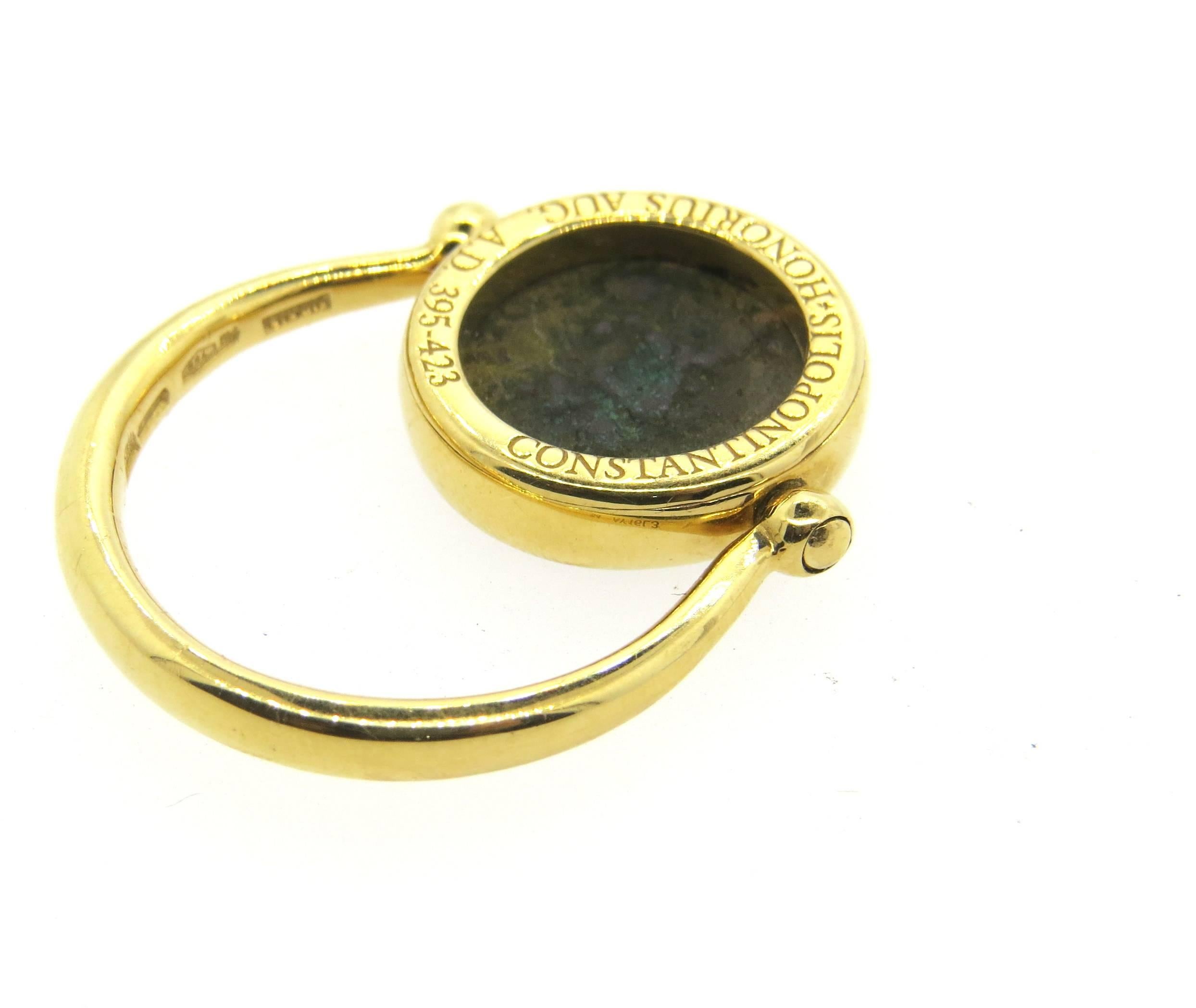 18k yellow gold ring, crafted by Bulgari for Monete collection, set with ancient coin in the center, featuring flip top. Ring is a size 6 1/2 - 6 3/4 (design of the ring yields slight size flexibility)  Top of the ring is 14.5mm in diameter. Marked