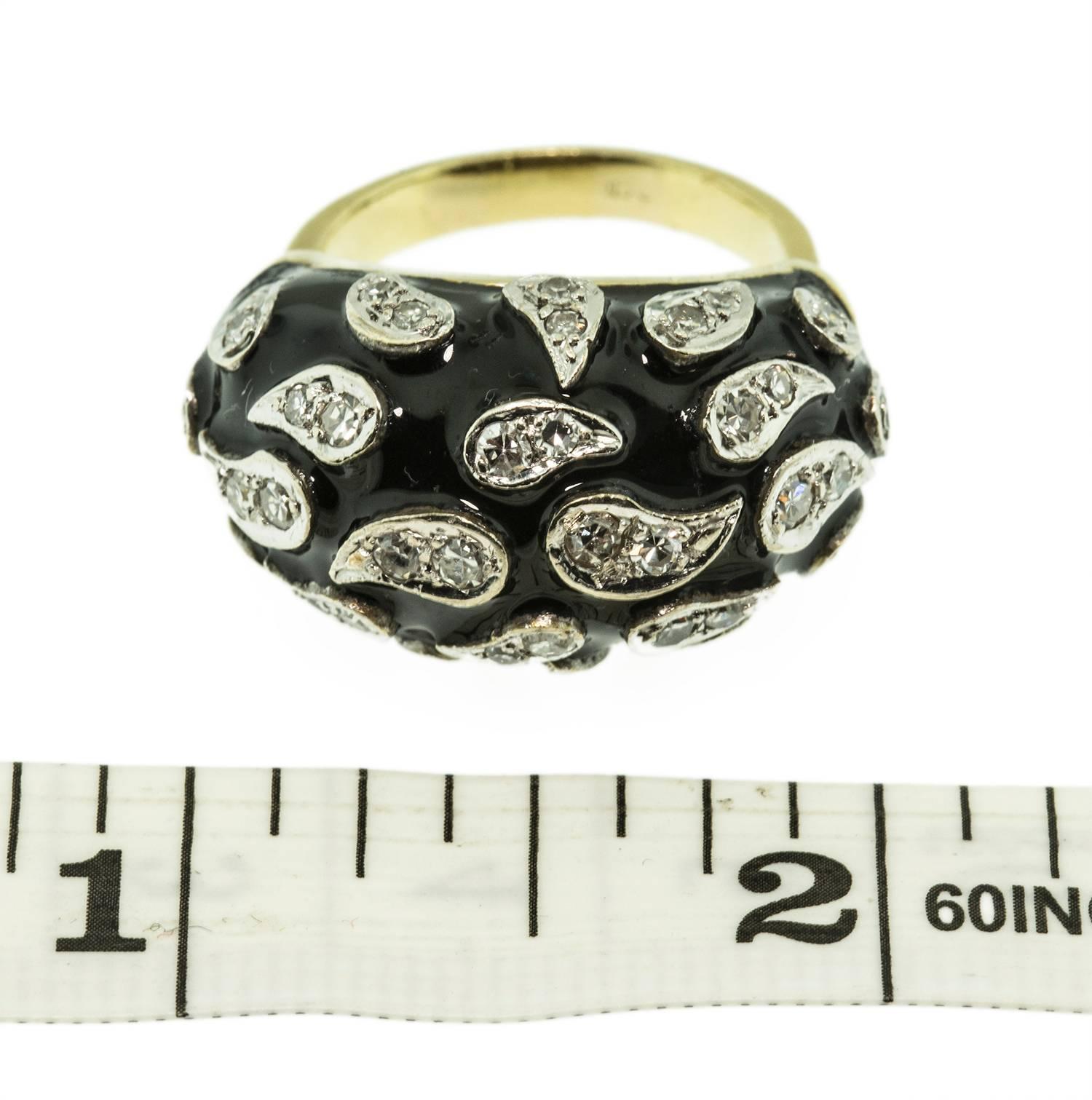 This custom made ring is set in 18k yellow gold. It holds thirty eight, round, single cut diamonds. F-I colour, VS-I1 clarity, set in stylized teardrops on a black enamel background. The high dome creates a dramatic avant-garde effect. This ring is