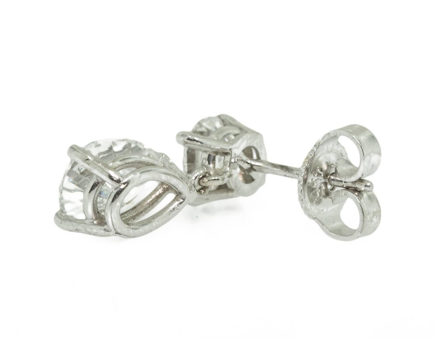 These charming earrings are set in 14k white gold. They dangle and flutter when worn allowing light to dance through each earring.The pear shapes each weigh 1 ct, G-H colour and SI1-I1 clarity. The top round brilliant diamond weigh .50 ct. each and