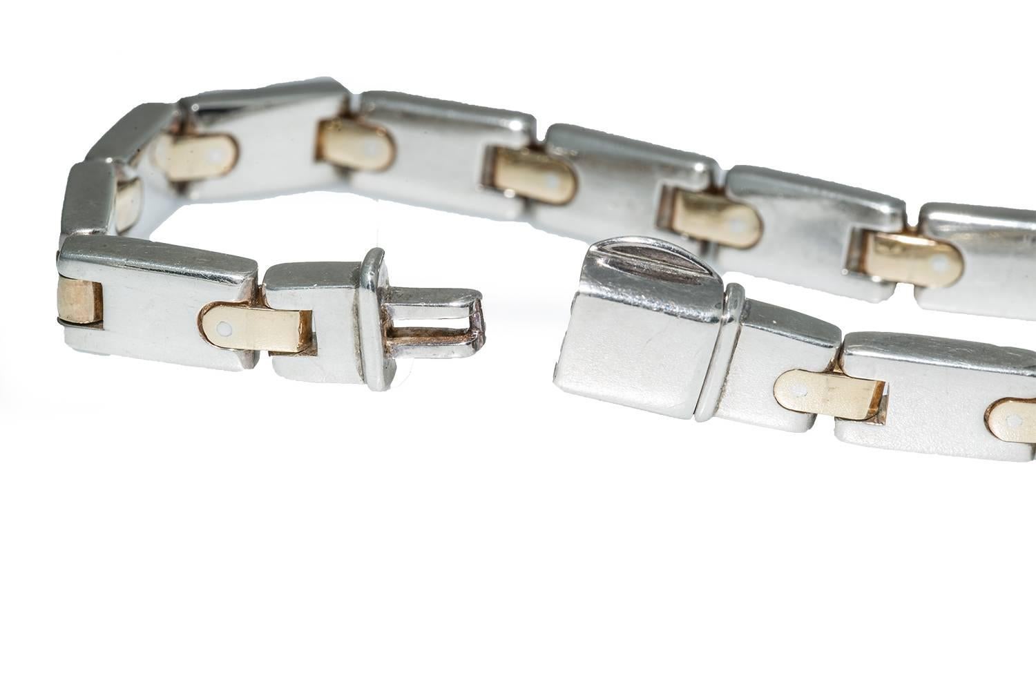 This Tiffany bracelet was made in Italy. It is clearly stamped with the Tiffany marks and 925/750 for silver and 18k gold. The construction is tailored and classic. This piece weighs 42.8 grams and is 7.5 inches long. It is in excellent condition.