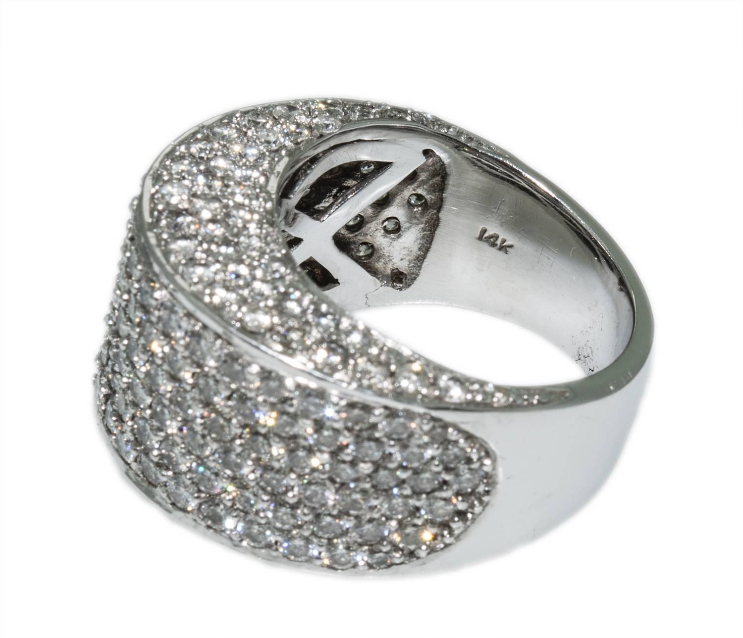 This brilliant ring is set in 14k white gold and holds 5ct. of bright white bead set diamonds (G-H, SI) The domed design is encrusted with diamonds which drape down over the finger. This ring currently measures size 8 and can be made smaller with