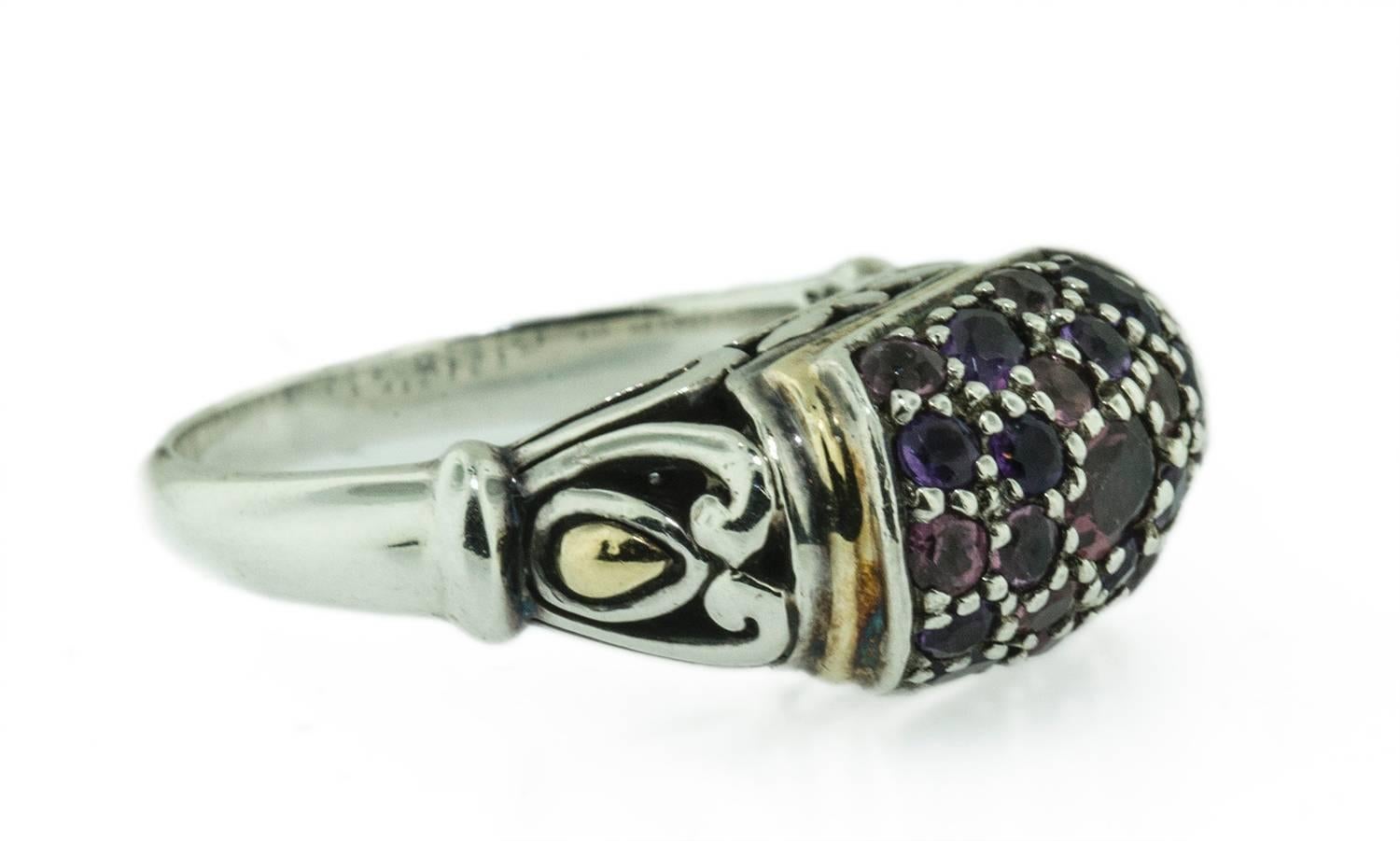 This beautifully designed ring is made by John Hardy. It is set in 18 KT gold and silver. It hold twenty two faceted garnets which are bead set. The workmanship of the mount is beautiful, which is typical of this exceptional designers work. The ring