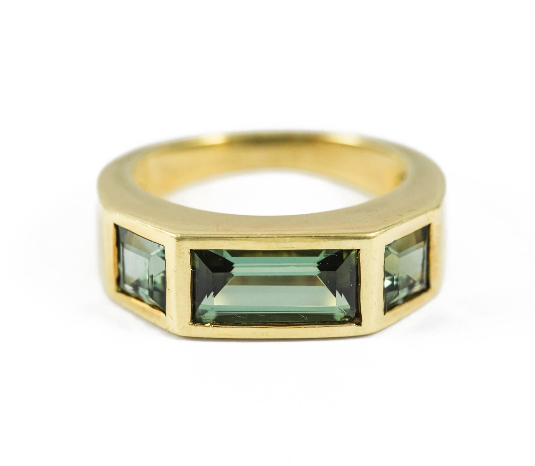 A green tourmaline and 18k yellow gold ring by Paloma Picasso for Tiffany & Co. The total weight of the vivid, strong colored and lush tourmaline's is 2.90 ct. 
Elegant and tailored this ring measures size 6 and is in excellent condition.