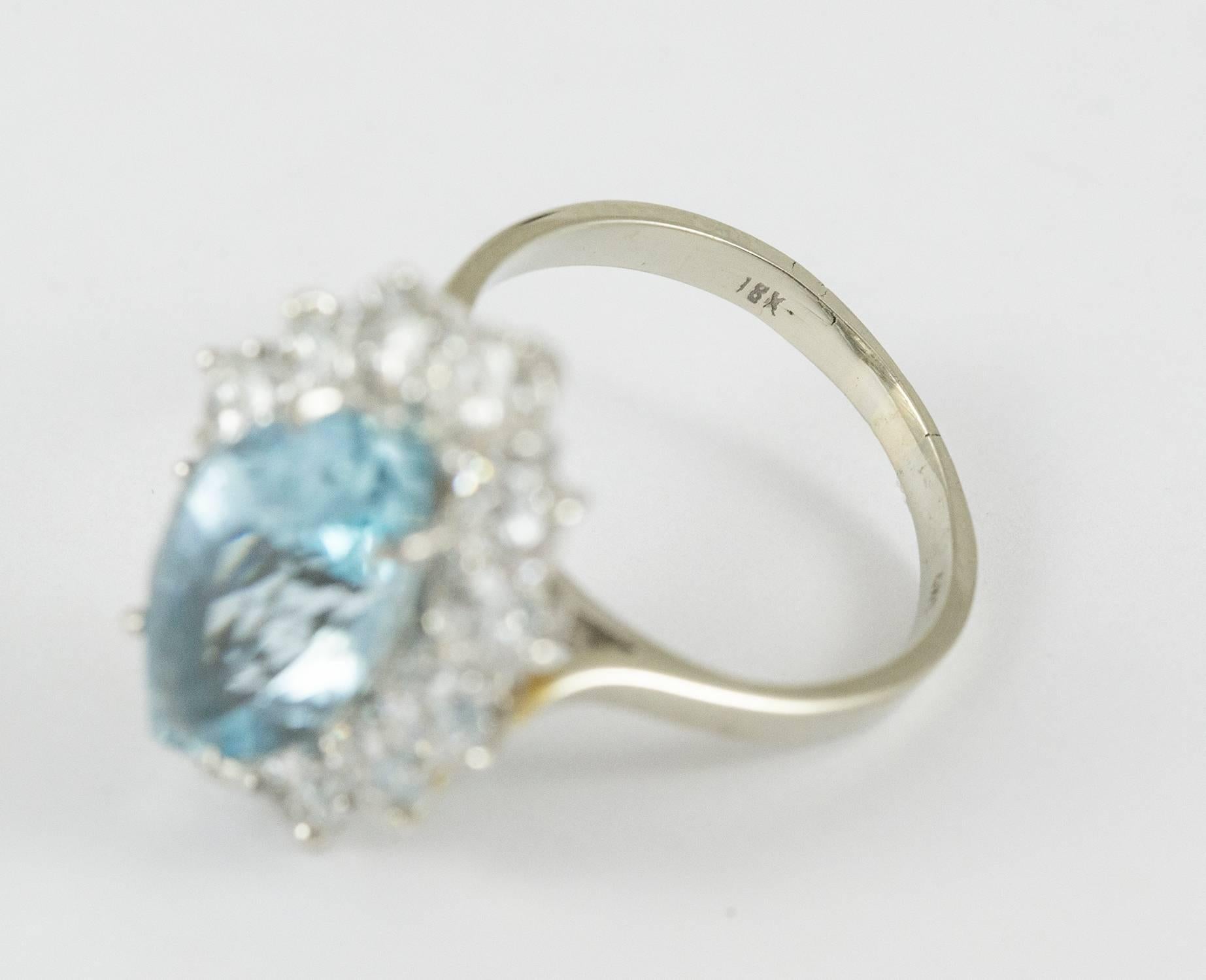 This striking aquamarine ring set in 18k white gold. It holds a bright, strongly coloured marquee cut aquamarine weighing approximately 4 ct. The vibrant aquamarine is framed by twelve brilliant cut diamonds weighting at total of 2.16ct. (F-G-H,