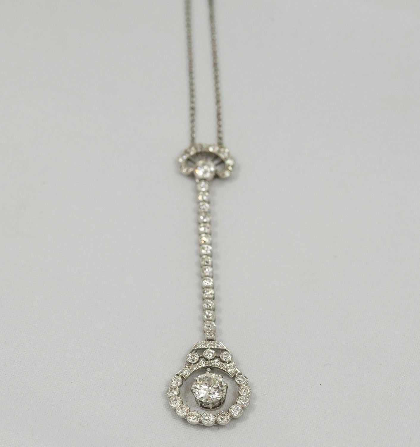 This beautiful Art Nouveau diamond necklace was made circa 1915. The large central old European cut diamond weighs .96 ct. (H colour, VVS2). It is suspended on a strand of old European cut diamonds which holds a circular embellished frame. In total