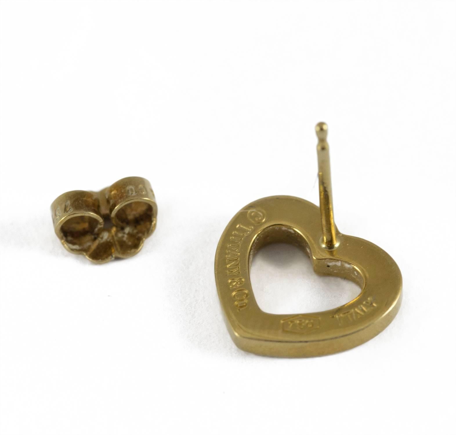 A dainty pair of Tiffany yellow gold open heart earrings. They are set in 18k yellow gold and are clearly stamped. They measure just under 1/2 inch in length and 1/2 inch in width.  These earrings are in excellent condition.