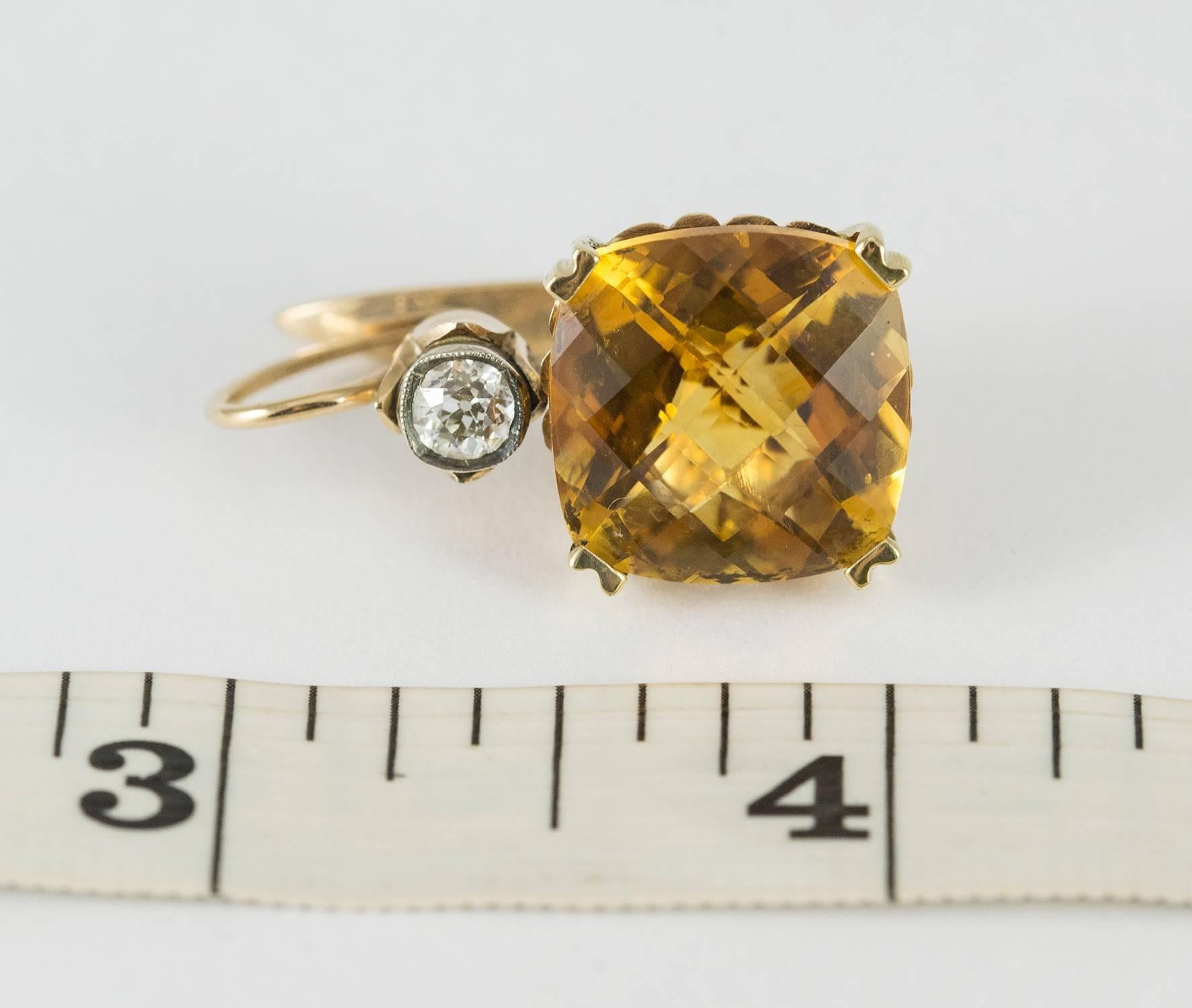These unique earrings are set in 14k yellow gold with two square cushion mixed cut citrines 24.85 ct.tw. They appear to be Russian in origin. The citrines are bright and have a strong saturation of yellow, orange and cognac. Embellishing the top of