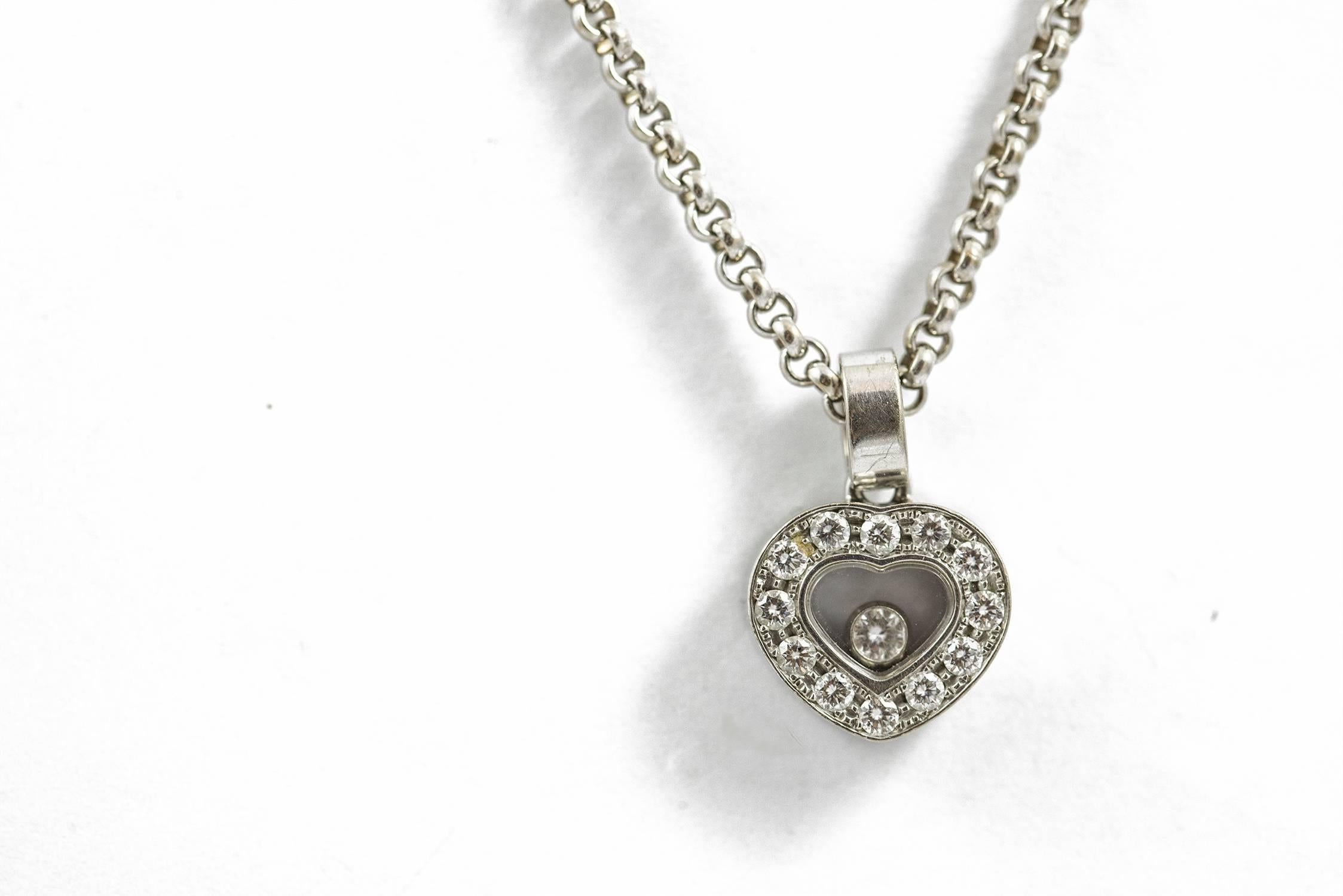 A vintage Chopard Happy Diamond necklace set in 18k white gold. The stylized signature heart holds thirteen high quality, round brilliant cut diamonds (.30 ct. E-F, VVS). This necklace measures 17 inches and the Chopard heart drops 1/2 inch below