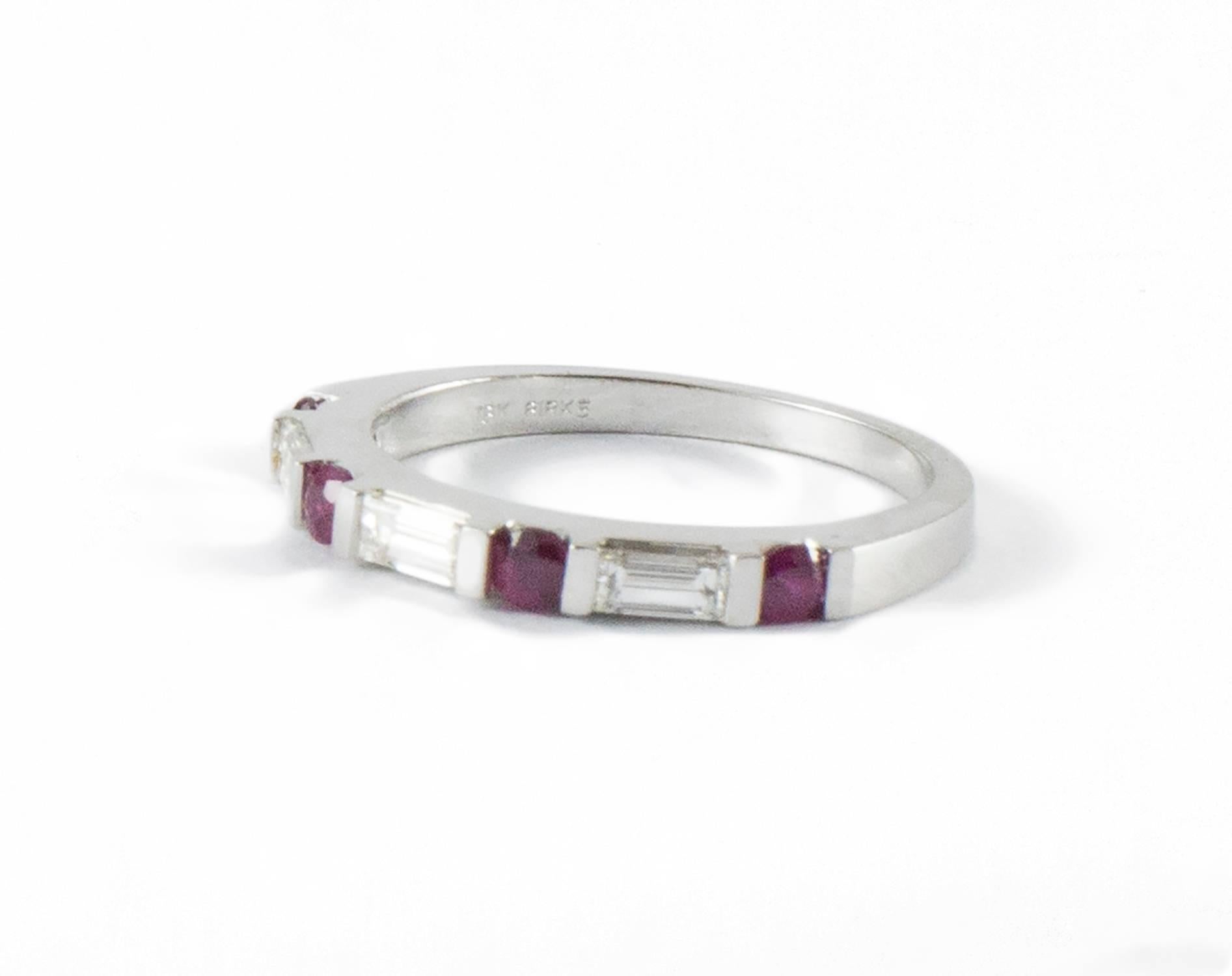 A Birks demi band set with four round crisp and bright ruby's (.35 ct.) and three channel set baguette's (.40 ct. F-G, VVS-VS). This excellent quality band stacks easily with other rings. It measures size 7 and is in excellent condition.