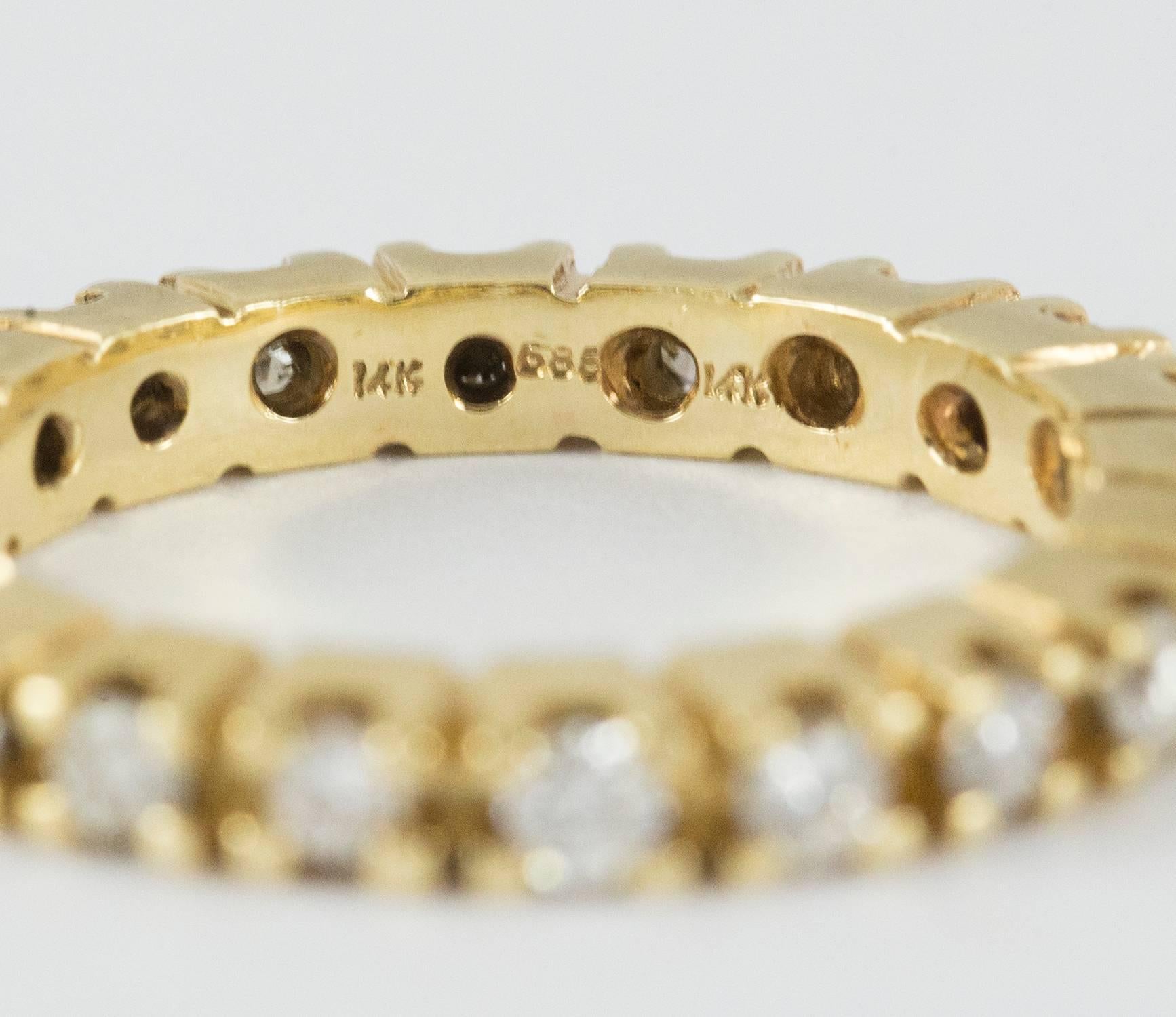A 14k yellow gold eternity band set with 20 round brilliant cut diamonds .60 ct. (I-J, VS-SI). This band is wider than average(1/8 inch) as seen in the thumbnail pictures. This piece measures 5.5 and is in very good condition.
