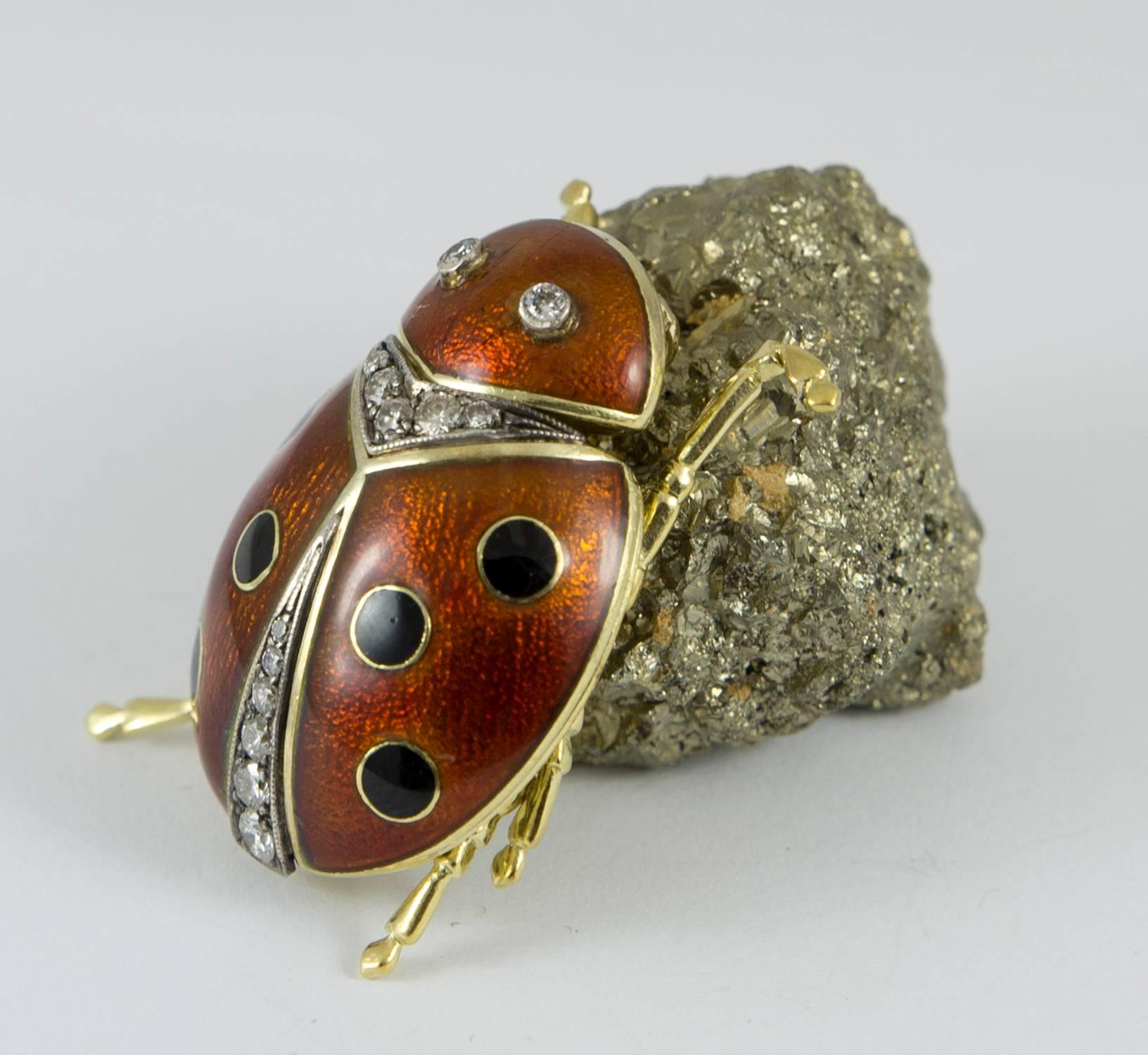 This charming lady bug is set in 18k yellow gold. Set with 13 round brilliant cut diamonds .52 ct. tw. The lady bug is hand enameled with a red background and black dots. This workmanship is done by a skilled Russian jeweler. The head, antenna and