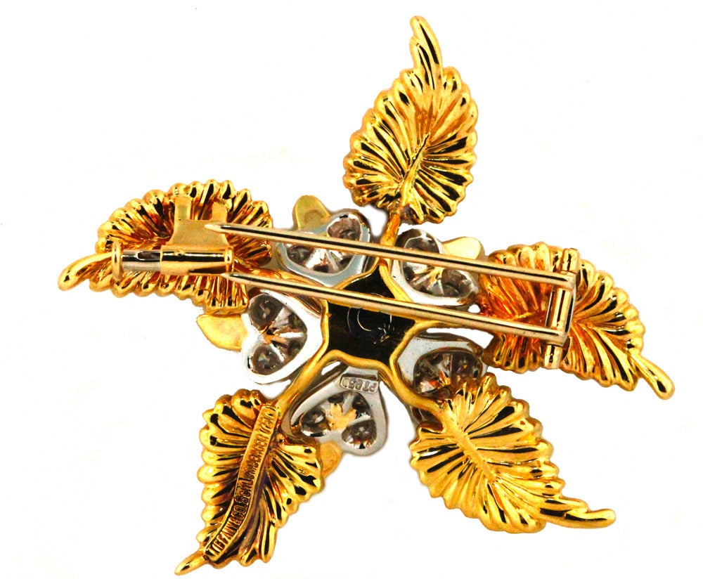 A Tiffany & Co. brooch clearly stamped Jean Schlumberger. Dating from approximately 1965 and and set in 18KT yellow gold and platinum. Set with over one carat brilliant round cut diamonds. The design is typical of Schlumberger who's favorite