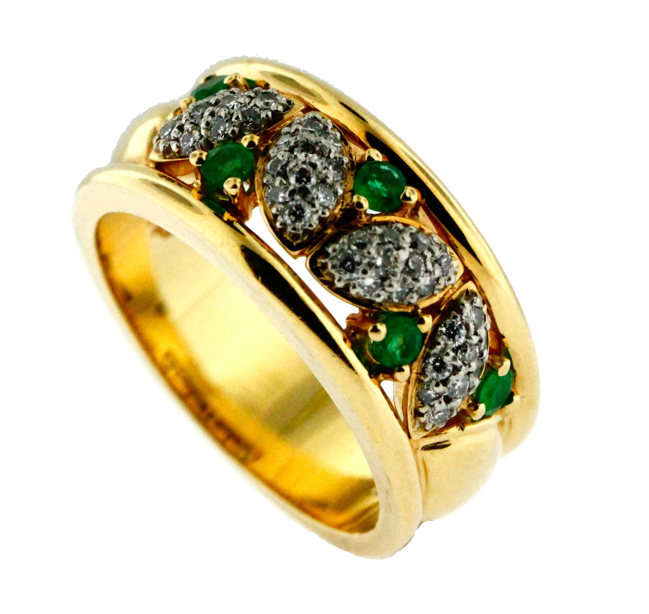 This elegant custom made ring is clearly stamped Birks JF. It was made in Montreal in the Birks factory approximately 25 years ago. It is also clearly stamped 18KT and platinum. The five mixed cut emeralds are vibrant with a slightly yellowish green