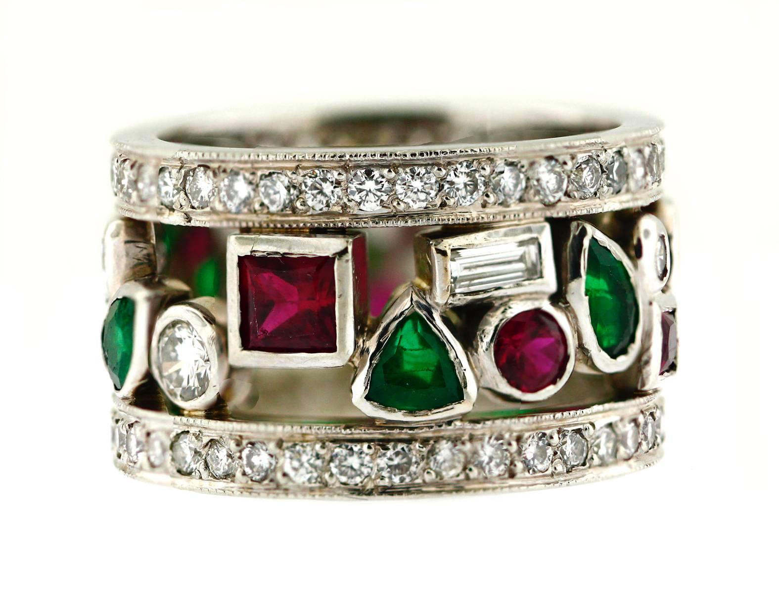 This beautiful band is clearly stamped 19KT. Additionally,this piece is trademarked. Two diamond encrusted eternity bands frame a patchwork of right crisp rubies, emeralds and diamonds. It is high quality and custom made with millgrain finishing.