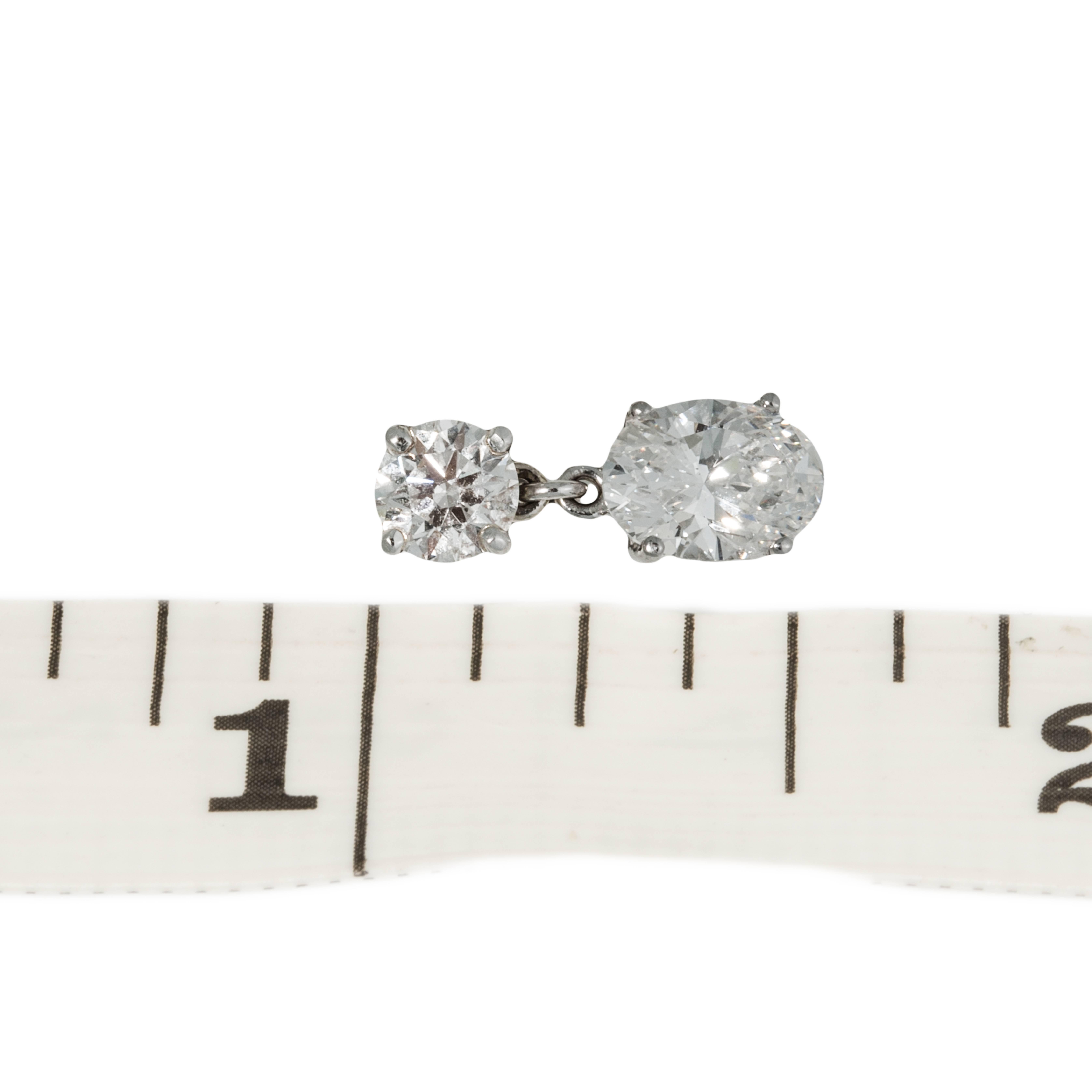 A lovely pair of 2 ct. tw. oval diamond drop earrings, F-G colour, SI2 clarity, with very good cut. They are suspended on two round, brilliant cut diamonds, weighing .85. ct. tw. F-G colour SI1-SI2 clarity, with very good cut also. These earrings