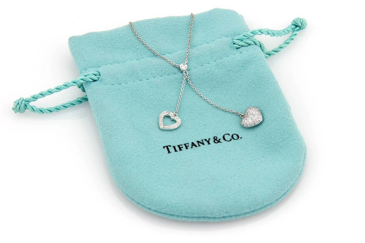 An exquisite little necklace by Tiffany & Co. set in platinum. The necklace suspends two delicate diamond set hearts .35 ct. tw. (G,VS1) A lovely memento for someone special. The necklace measures 16 inches and the diamond drop measures 1.5 inches.