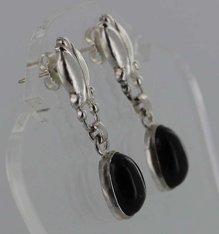 Georg Jensen sterling silver with earrings with Garnet Cabochons.Imropessed company marks for Georg Jensen Denmark no17 Sterling

These earrings are fro pierced ears. Approximately 1 3/8