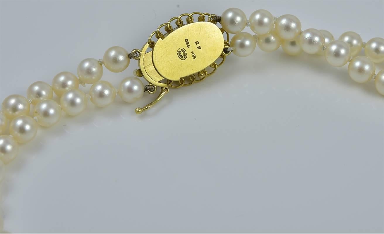 Georg Jensen Pearl Necklace No. 43 with Moonstone.  This necklace is a double strand of graduated pearls ranging in size from 6 to 8.75 mm. There are a total of 135 pearls. The necklace has a 18 karat yellow gold clasp set with large cabachon