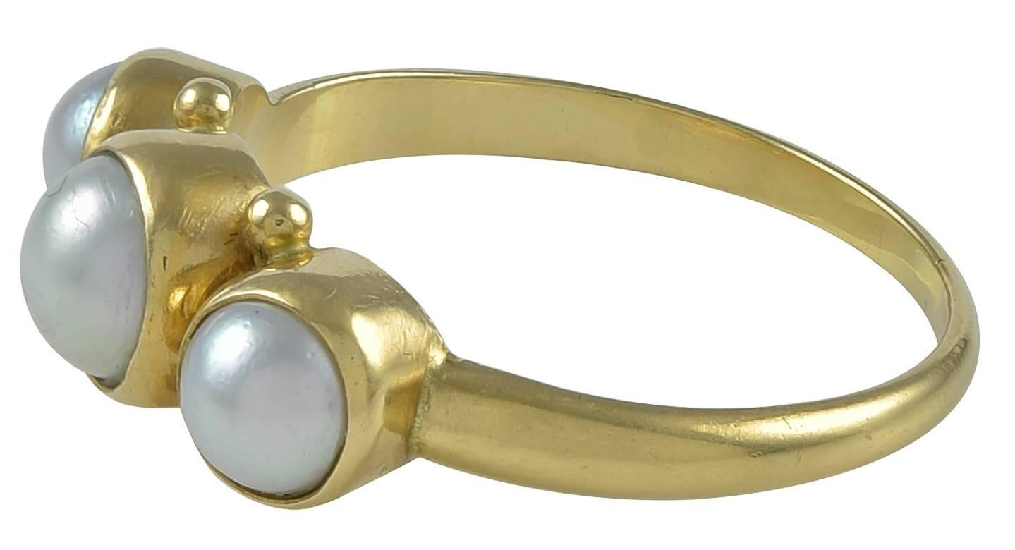 Georg Jensen Gold Ring No. 1003 with Pearls. This ring is in 18 karat yellow gold and is set with three pearls.  The ring measures 8.35.  The ring bears impressed marks for Georg Jensen, 1003, 750.  The ring is in excellent condition.