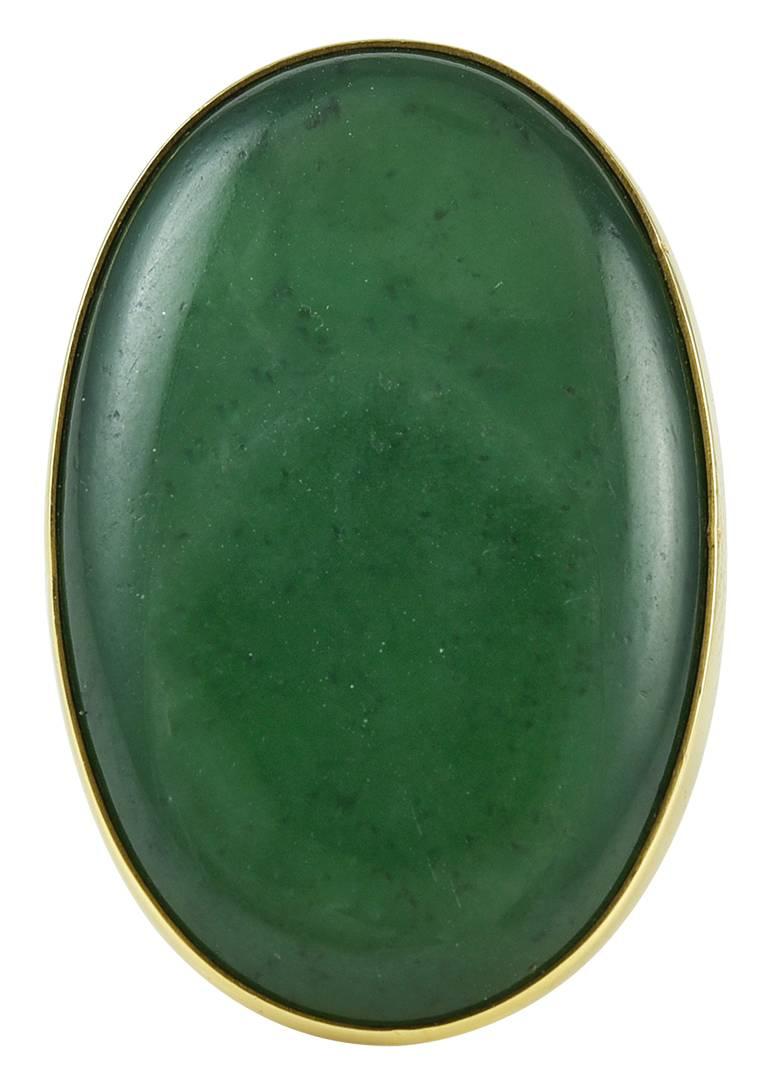 Georg Jensen Gold Ring No. 1090B with Jade.  This 18karat yellow gold ring is set with large oval spinach green jade.  The ring is size 7 and bears impressed company marks for Georg Jensen, 750, 1090 B.  The ring is in excellent condition.
