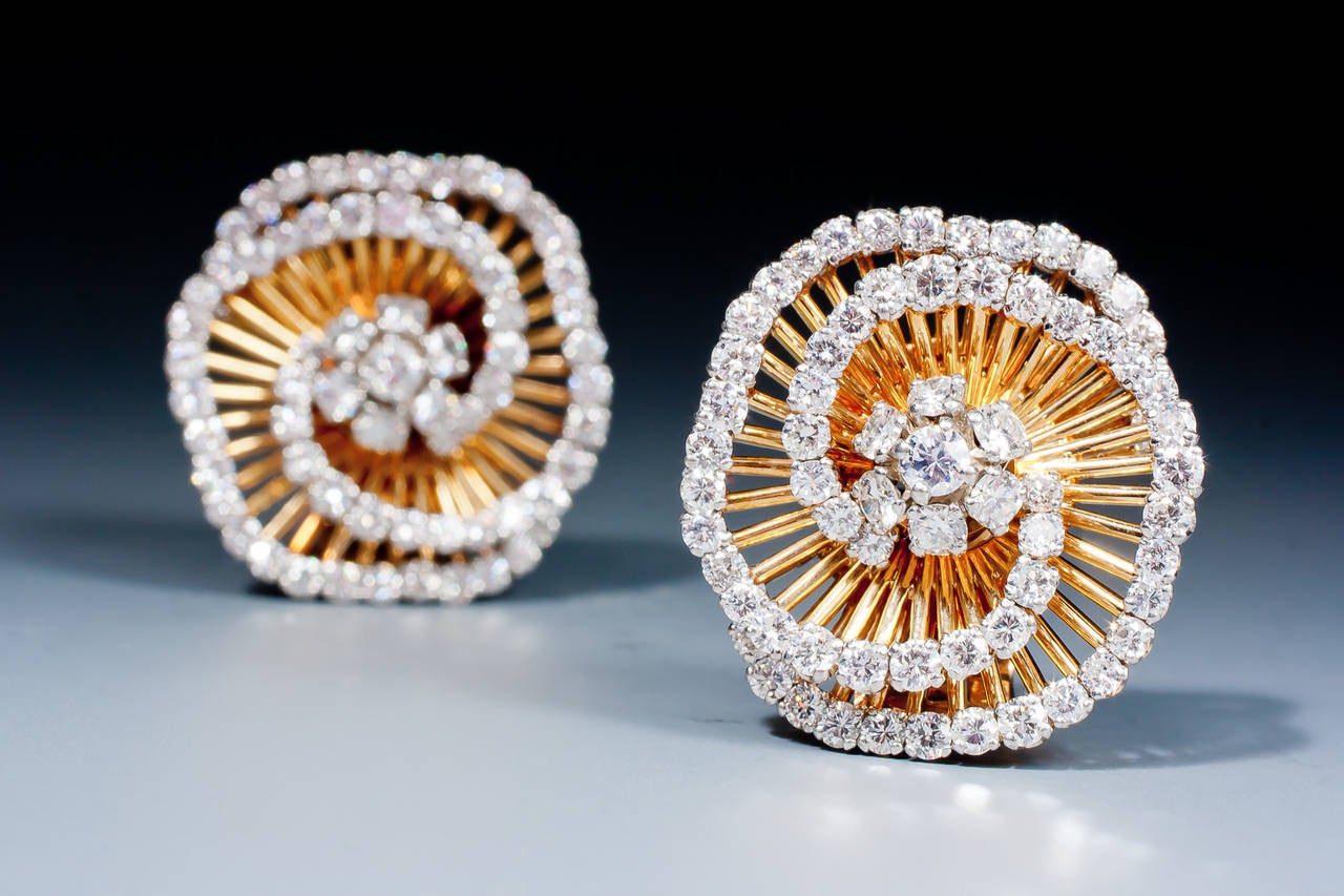A gorgeous pair of diamond tourbillon 'cheveux d'ange' earrings by Van Cleef & Arpels, designed as a diamond cluster, surrounded by graduated gold rods of angel hair design with diamond tips, mounted in platinum and 18 karat gold.
These earclips