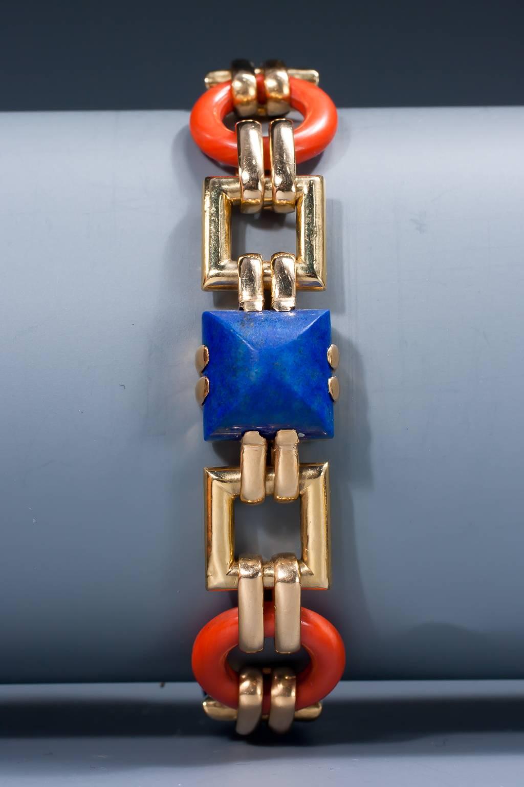 A rare Art Deco gold, lapis and coral bracelet by Cartier, composed of 3 circular coral links, 3 sugarloaf cut lapis lazuli and 6 square links in 18 karat gold.

According to the Cartier archives this bracelet was made by Georges Lenfant for
