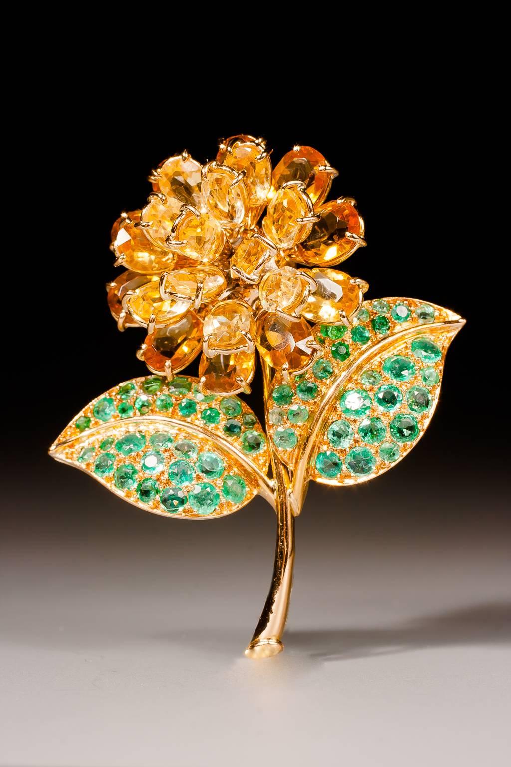 A beautiful and rare gold, citrine and emerald flower brooch by René Boivin, designed as a dahlia, the flower set with oval citrines, the leaves set with round cut emeralds, mounted in 18 karat yellow gold. Safety clasp.

Hallmarks: French assay