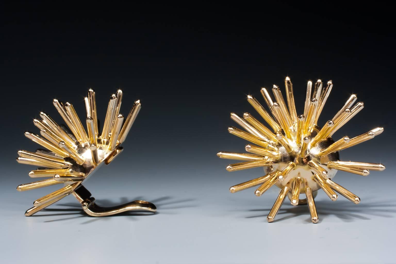 A great pair of sputnik earrings by Cartier, mounted in yellow gold. With clip backs. Signed Cartier and numbered.

Hallmark: 14K stands for 14 karat gold. 

New York, circa 1957-1960.
