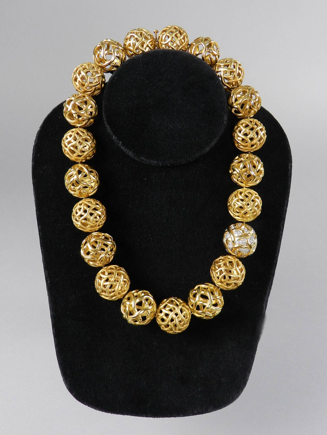 Angela Cummings 18k yellow gold and diamond pave ball necklace. She designed jewelry at Tiffany and Co. from 1969 to 1984. The necklace has 20 alternating open-work balls in matte brushed gold and shiny gold finish, and 1 diamond pave ball. It is