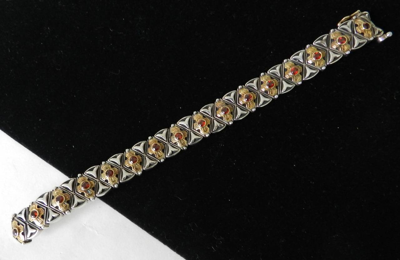 Konstantino sterling silver, 18k yellow gold and garnet bracelet. Excellent previously owned condition. Byzantine style design. 7