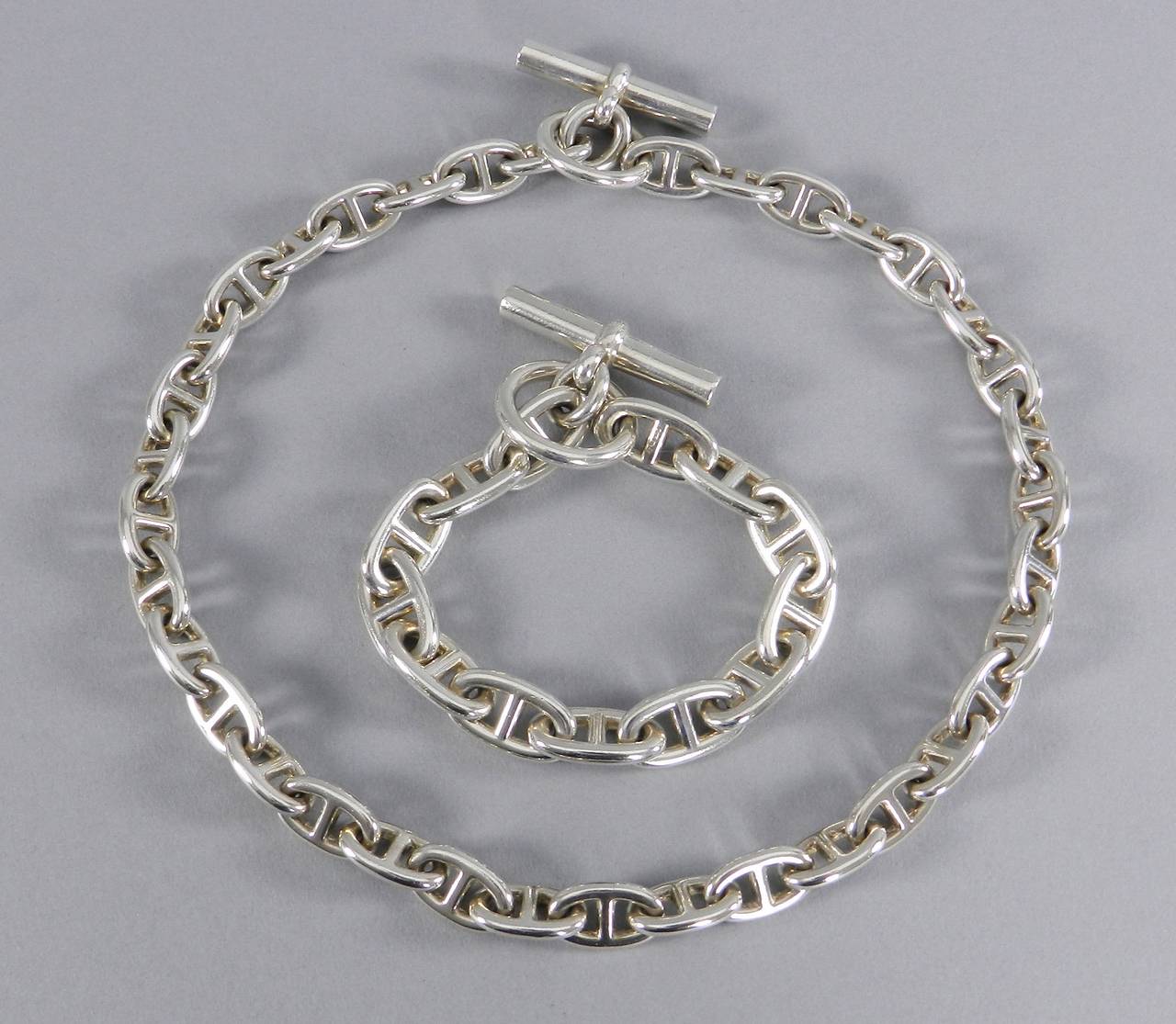 Hermes Chaine d'Ancre sterling silver necklace and bracelet. Necklace is the MM size with 36 links and measures 43.5 cm. The bracelet is the GM size with 12 links and measures 7