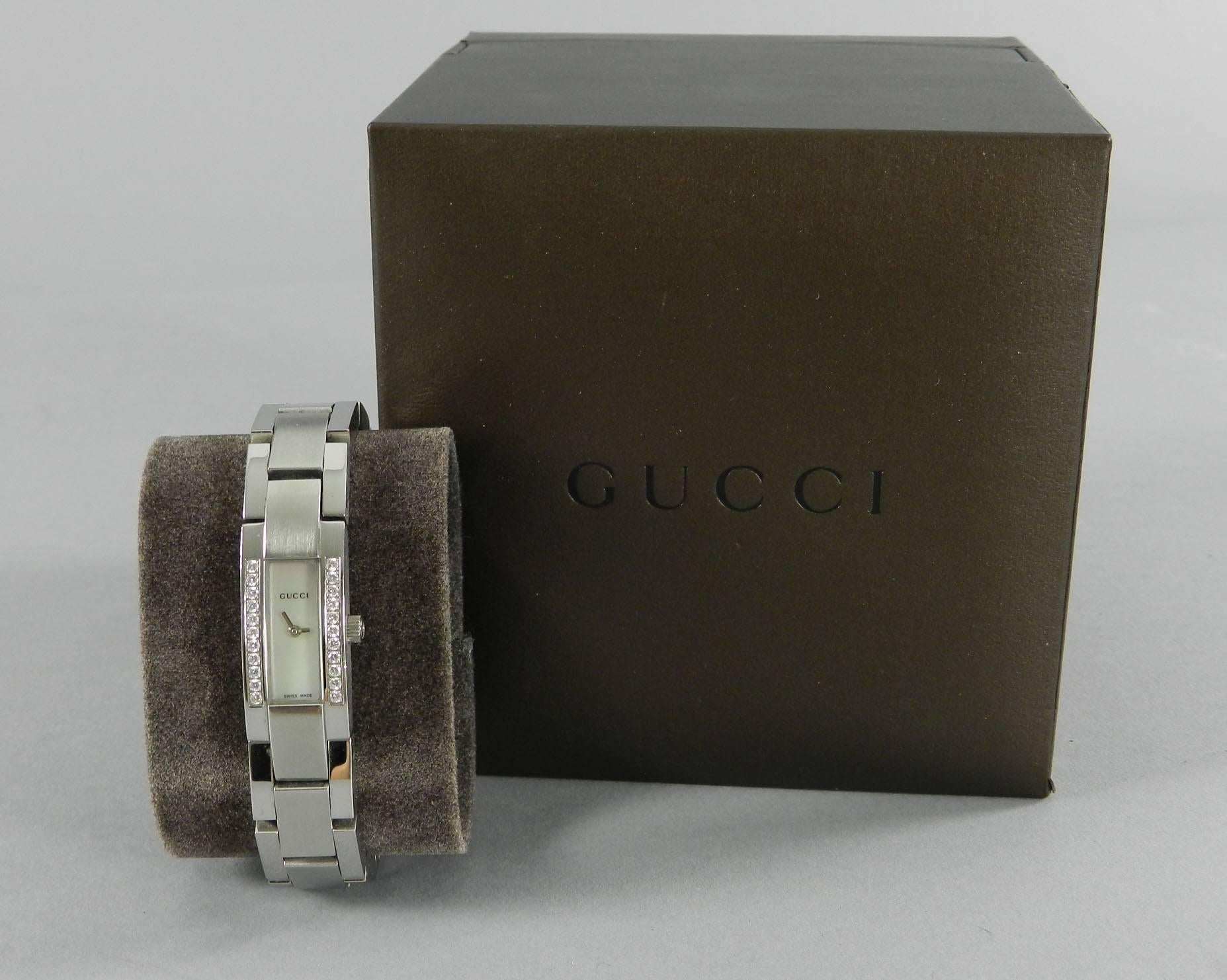 Gucci ladies stainless steel watch with mother of pearl face and diamonds. Model 4600L. Original retail $2290+. Pre-owned. Front face measures 5/8