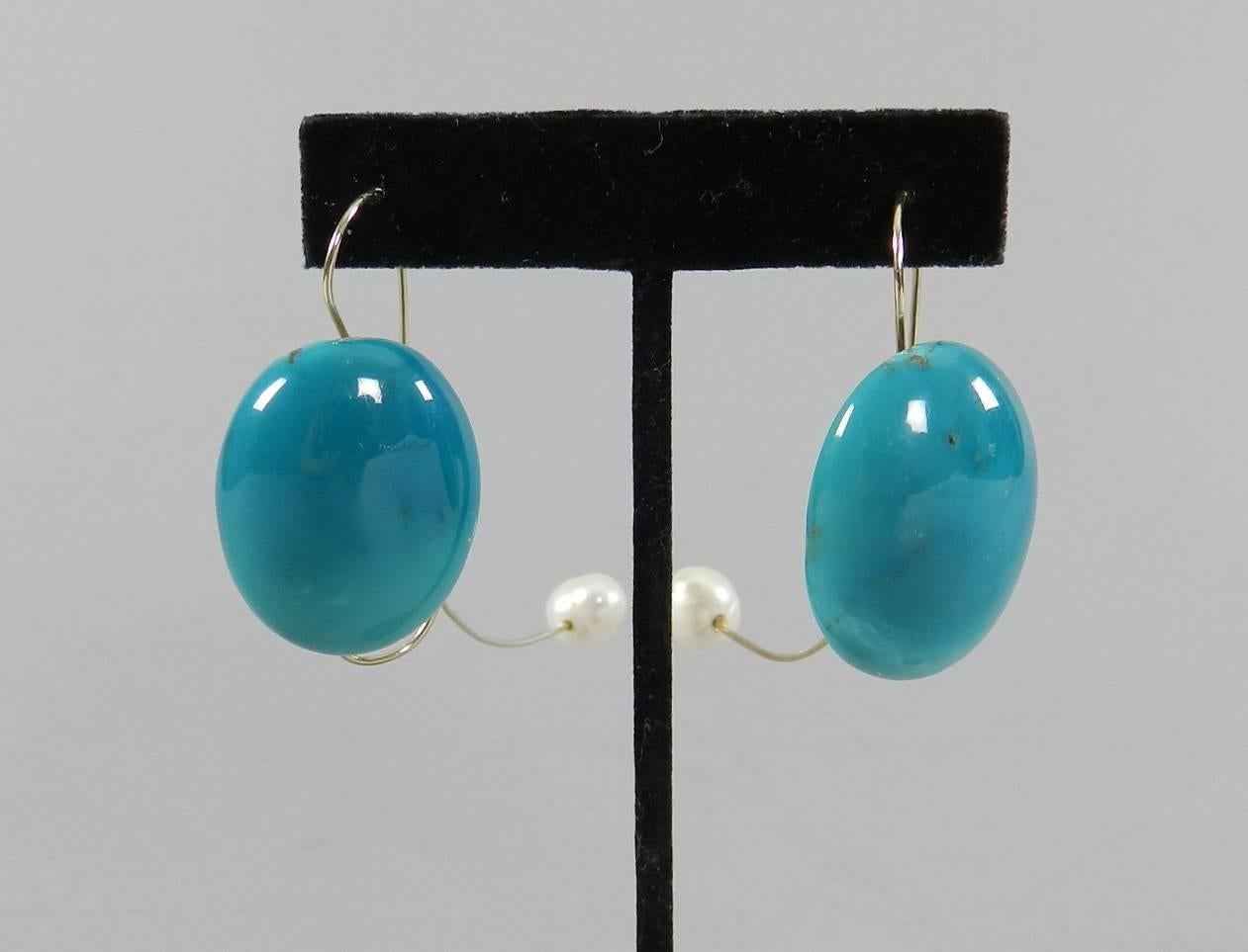 Angela Pintaldi turquoise, 18k gold wire, and pearl modernist abstract earrings.  The pearl ends unscrew to allow earrings to go on. Measures about 3.25” x 7/8”.

We ship worldwide. Canadian residents pay sales tax based on destination province. 