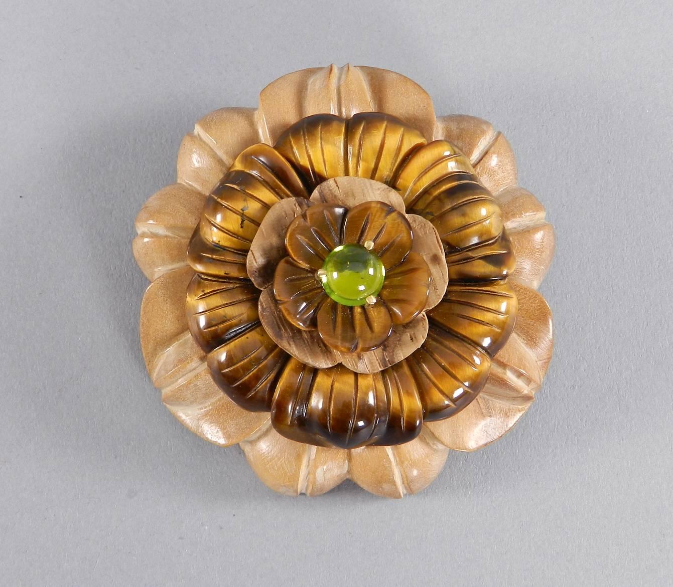 Bettina for Seaman Schepps carved flower brooch. Wood, Tiger eye, peridot, and 18k yellow gold. Excellent condition. Circa 2000. Measures 60 mm across and is 20mm deep.

We ship worldwide.