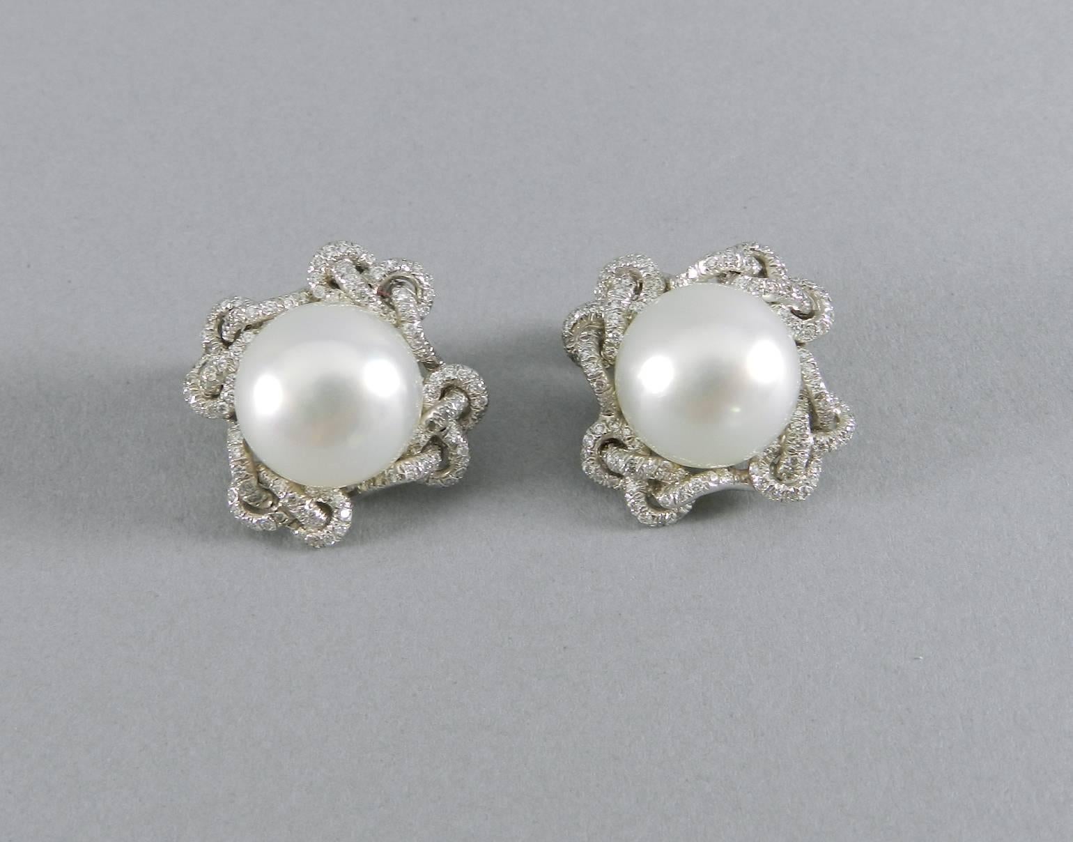 Verdura south sea pearl, platinum, diamond clip earrings.  South sea cultured pearl centre surrounded by platinum braided pave diamond lace border.  

Pearls measure approximately 14.7 x 12.8 mm and 14.6 x 12.5 mm.  White color with smooth finish,