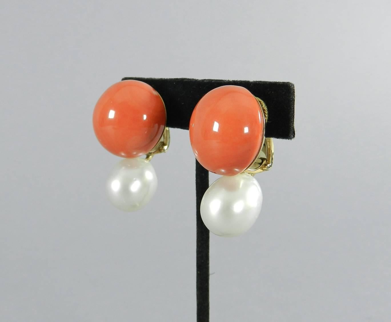 Coral and baroque south sea pearl 18k gold earrings.  Classic design with yellow gold clipbacks. Hallmarked 750 on earring base and clip.  The south sea pearls measure about 14-15 x 16mm and the coral button 21mm.  Total weight 44.5 grams. Excellent