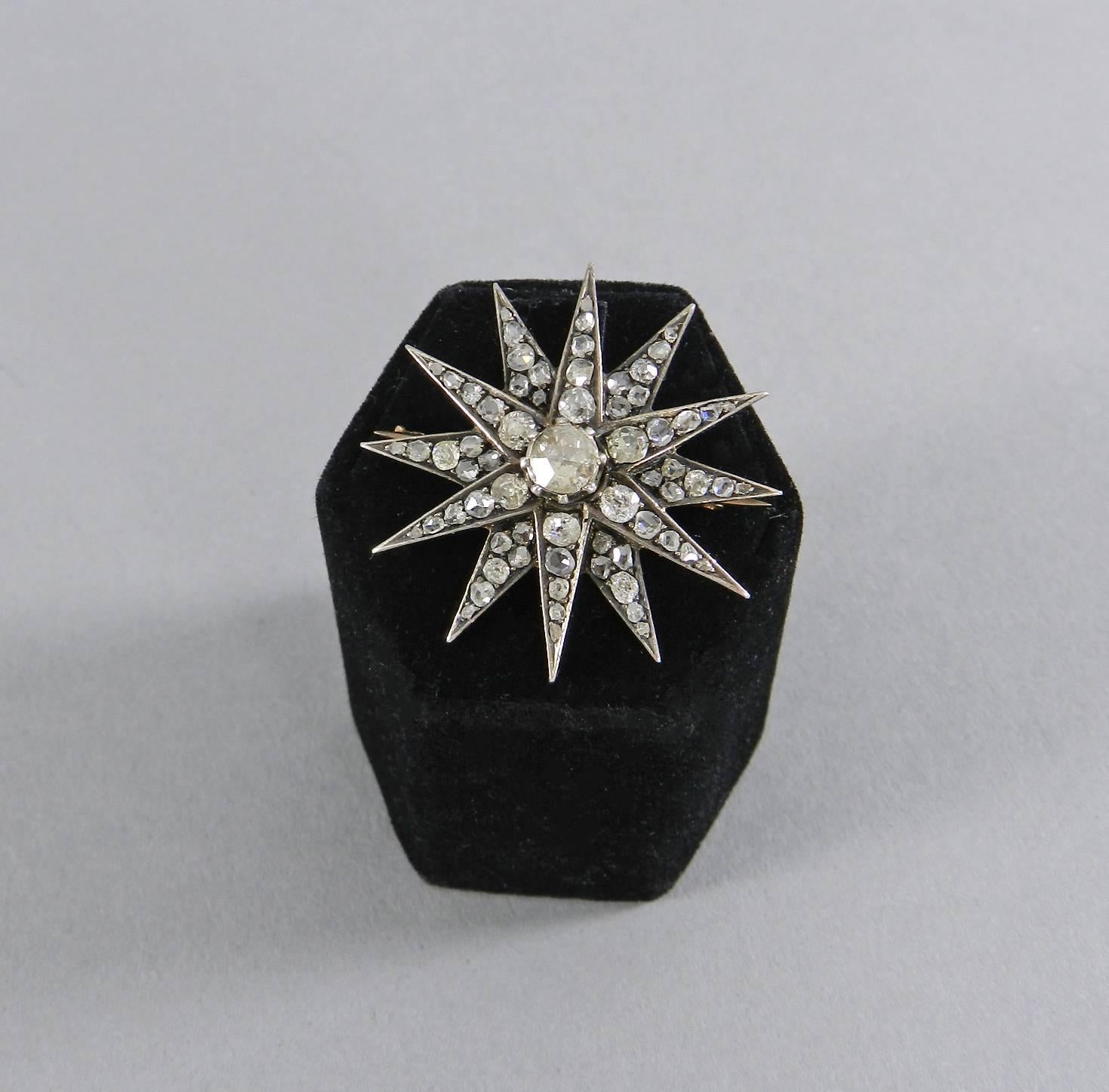 Antique Victorian Rose cut Diamond Star brooch.  Diamonds are set in silver topped 14k gold.  Centre rose cut diamond of approx. 0.5 ctw with SI2 clarity and J-K color.  Other old mine cut diamonds are approx. 3.0 ctw for a total of approx. 3.5ctw