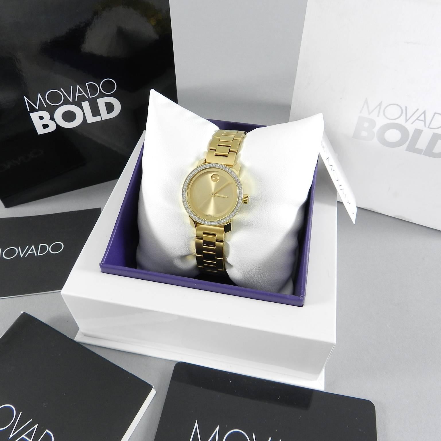 Movado signature museum watch in goldtone stainless steel and pave diamonds.  Brand new in box with all papers and tags. 
Swiss quartz movement
Water resistant to 3 ATM
Round polished goldtone ion-plated stainless steel case, 25mm (1")
Pavé