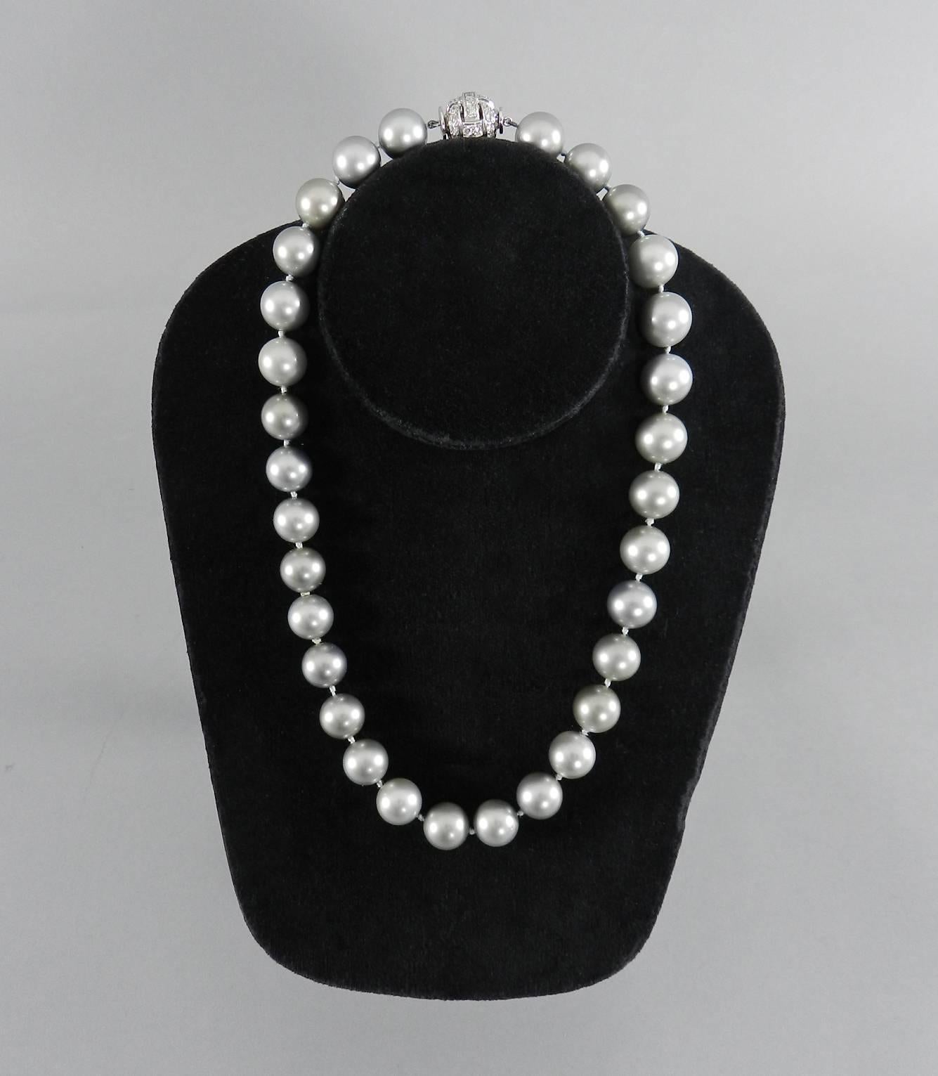 A tahitian cultured pearl necklace with platinum and diamond clasp.  29 gray pearls with silver / green overtones measuring 12-13mm.  18