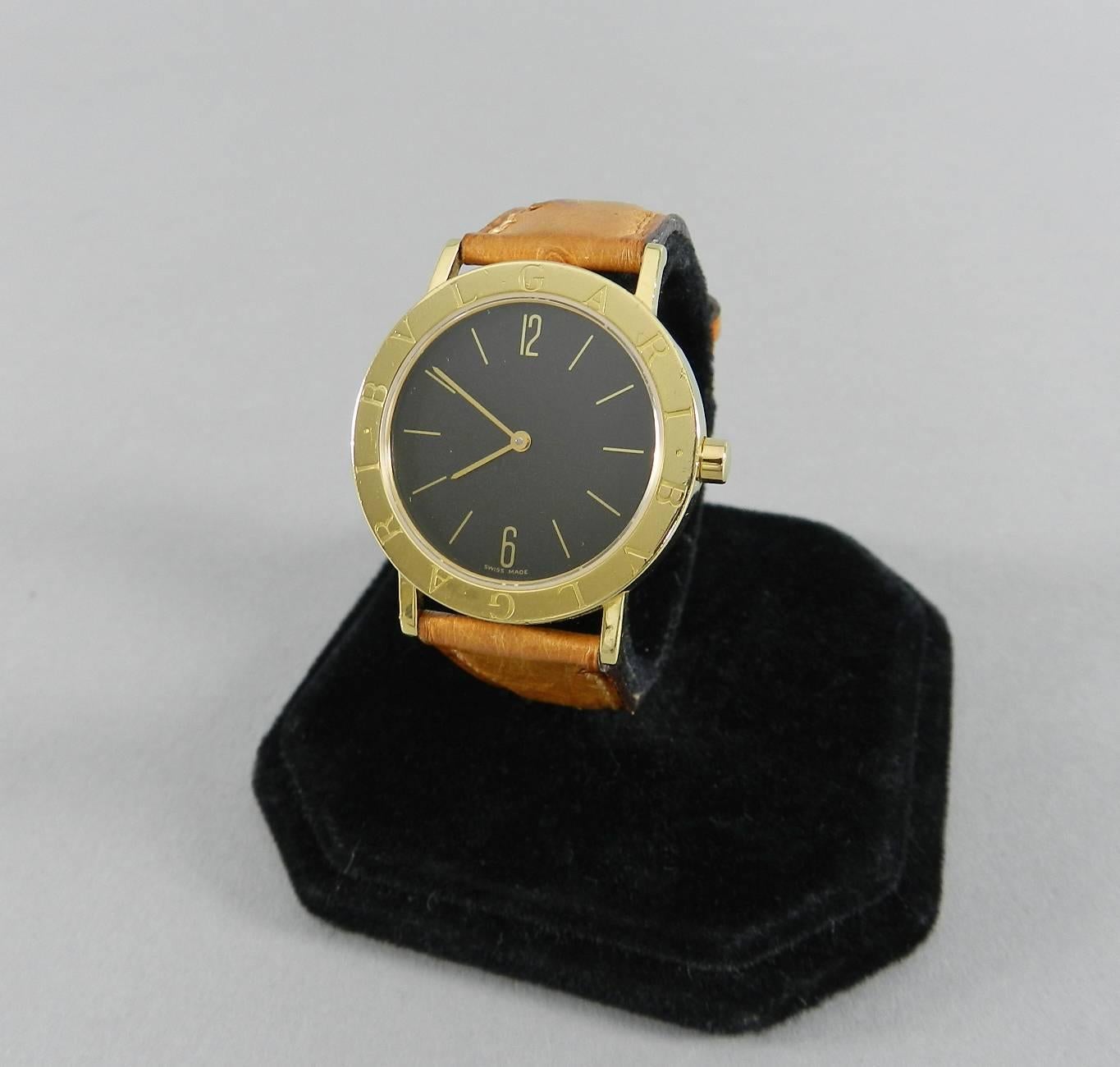 Bulgari 18k yellow gold watch.  Black face with gold hands and numbers. Style number BB33GL.  Quartz movement, 33mm case, hallmarked Bvlgari 750 on buckle. Tan ostrich band has been used a few times.  Beige and black crocodile bands that are brand