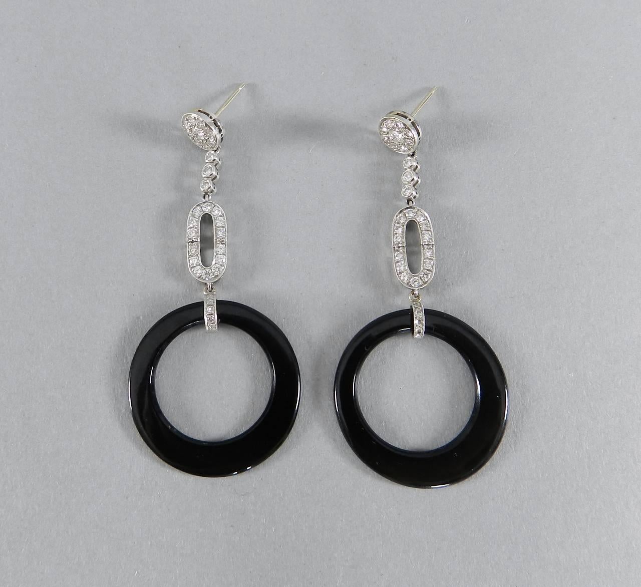 1920's Art Deco 14k White Gold, Diamond, Onyx Drop Earrings.  Vintage earrings originally purchased at Demner New York.  Hinged long drop design, round onyx rings, and posts for pierced ears.  Total gross diamond weight approx. 1.42 ct and total