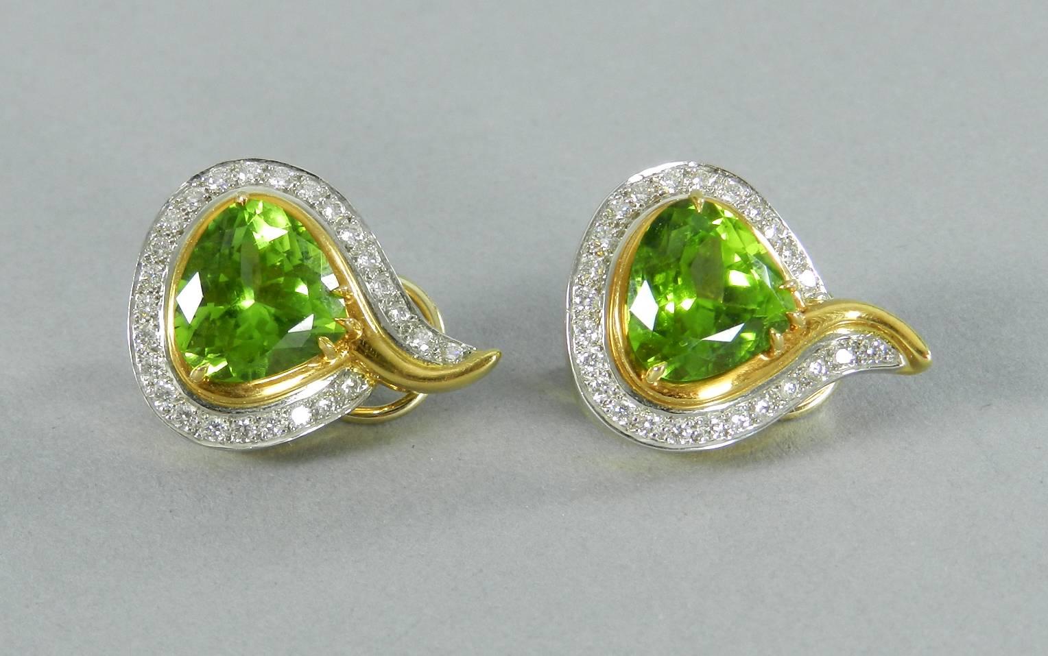 Angela Cummings 18k yellow and white gold earrings with diamonds, and peridot. Clip on. Excellent condition. Hallmarked 1998 Cummings 18k. Measures 1 -1/8" tall and 7.8" wide. 

Shipping prices are for tracked ground service to the US.