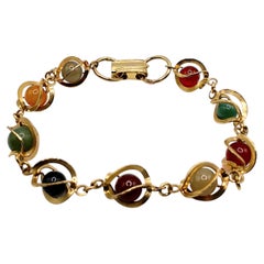 Pulsera vintage de los años 80 con eslabones dorados y esferas planetarias de piedras preciosas multicolores