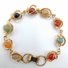 Pulsera vintage de los años 80 con eslabones dorados y esferas planetarias de piedras preciosas multicolores