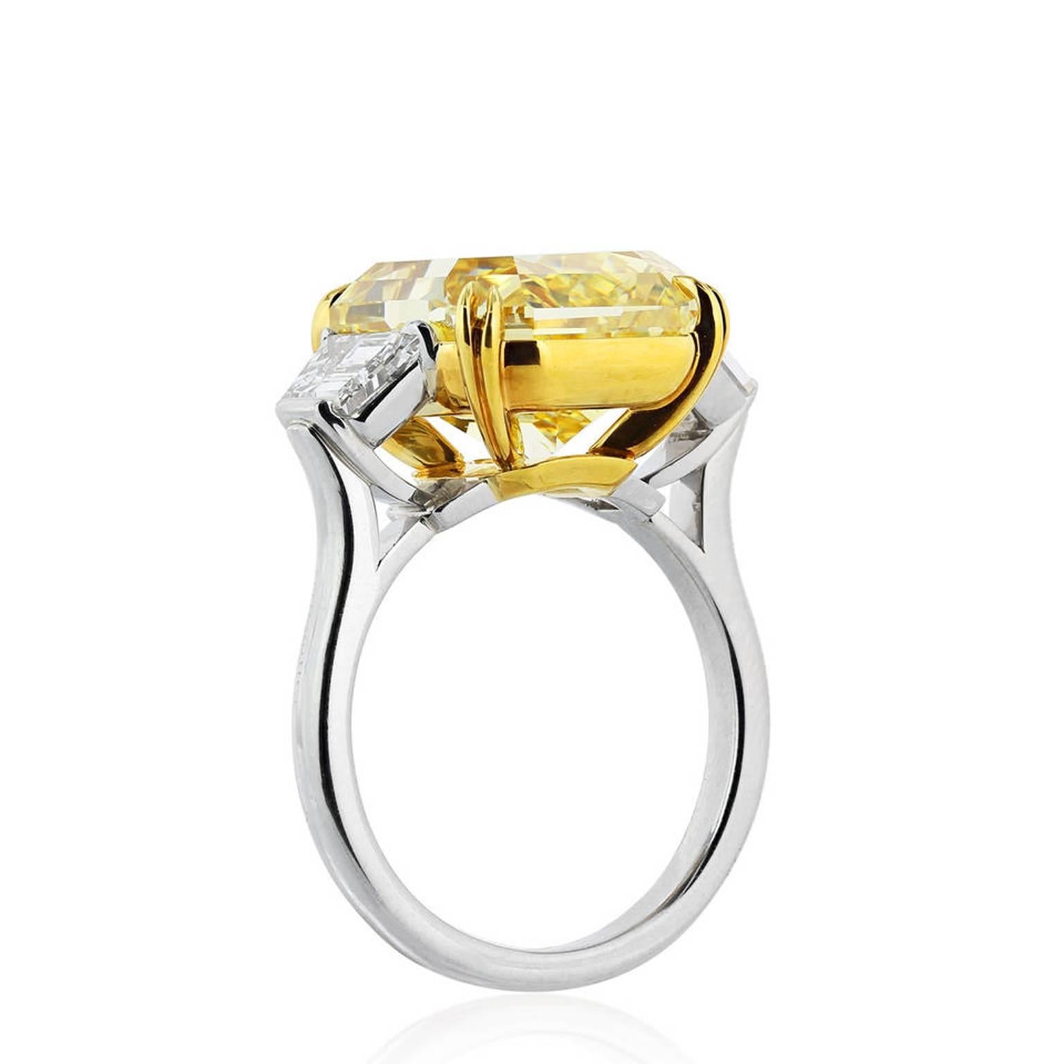 Magnificent Platinum and 18 Karat Yellow Gold Fancy Yellow Diamond Engagement Ring With Center GIA Certified 10.18 Carat FIY-IF Radiant Cut Diamond Set with Two Step Trapezoids, features 1.75 Carat of Diamond Weight. The Ring available in 6 size,
