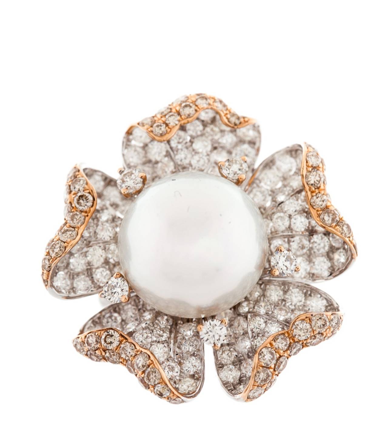 Very unique combination of fashion and elegance, 11MM South sea Pearl set with five diamond petals totaling 5.70 Carats of diamonds. 
Designed by Diana M.