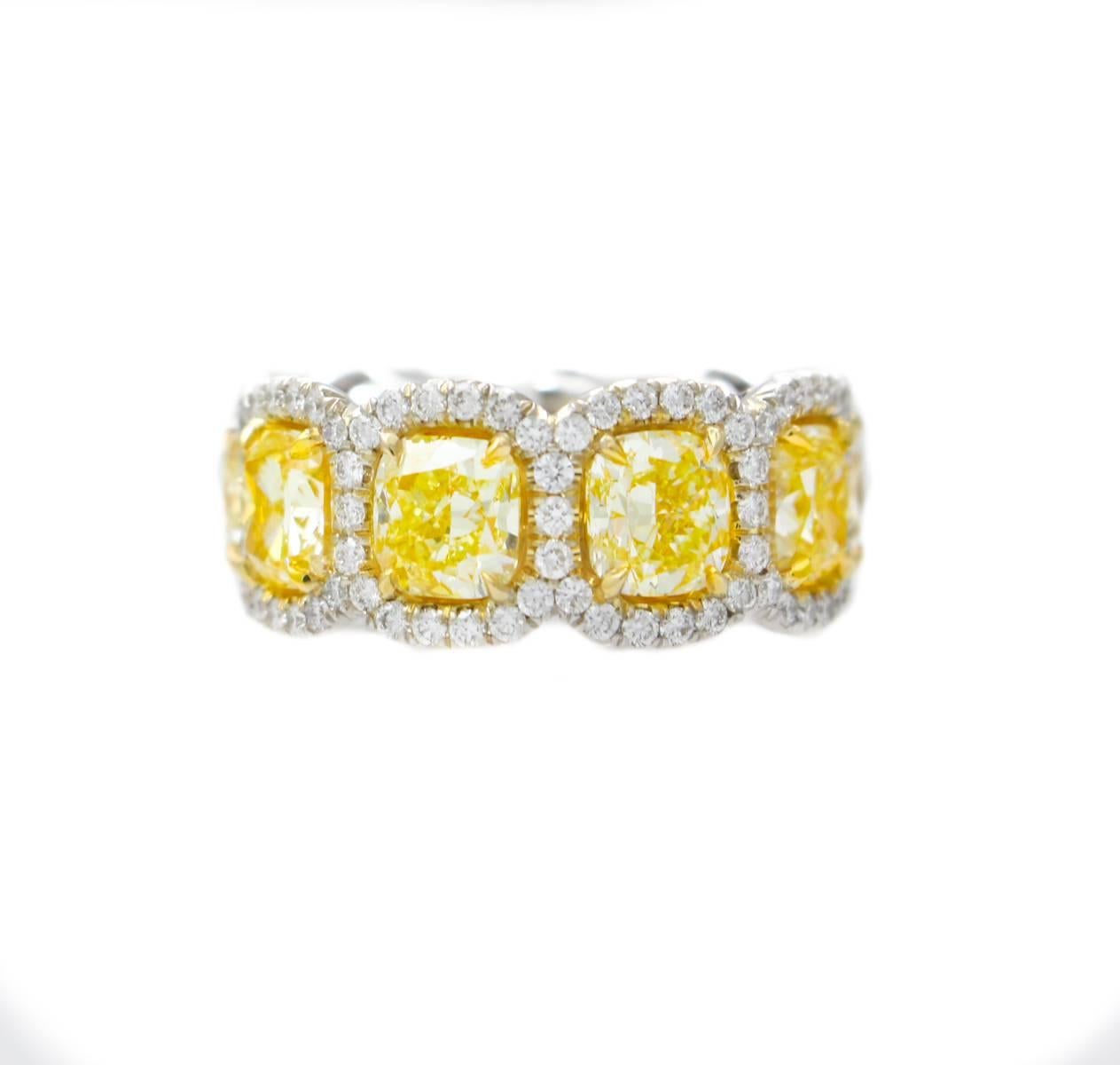 Magnificent Fancy Yellow diamond eternity band, features 9.50 Carats of Fancy Yellow Cushion Cut Diamonds, surrounded by 1.50 Carats of white round brilliant cut diamonds. Each stone is approximately 1.00 carats, cushion cut.
Beautiful vibrant