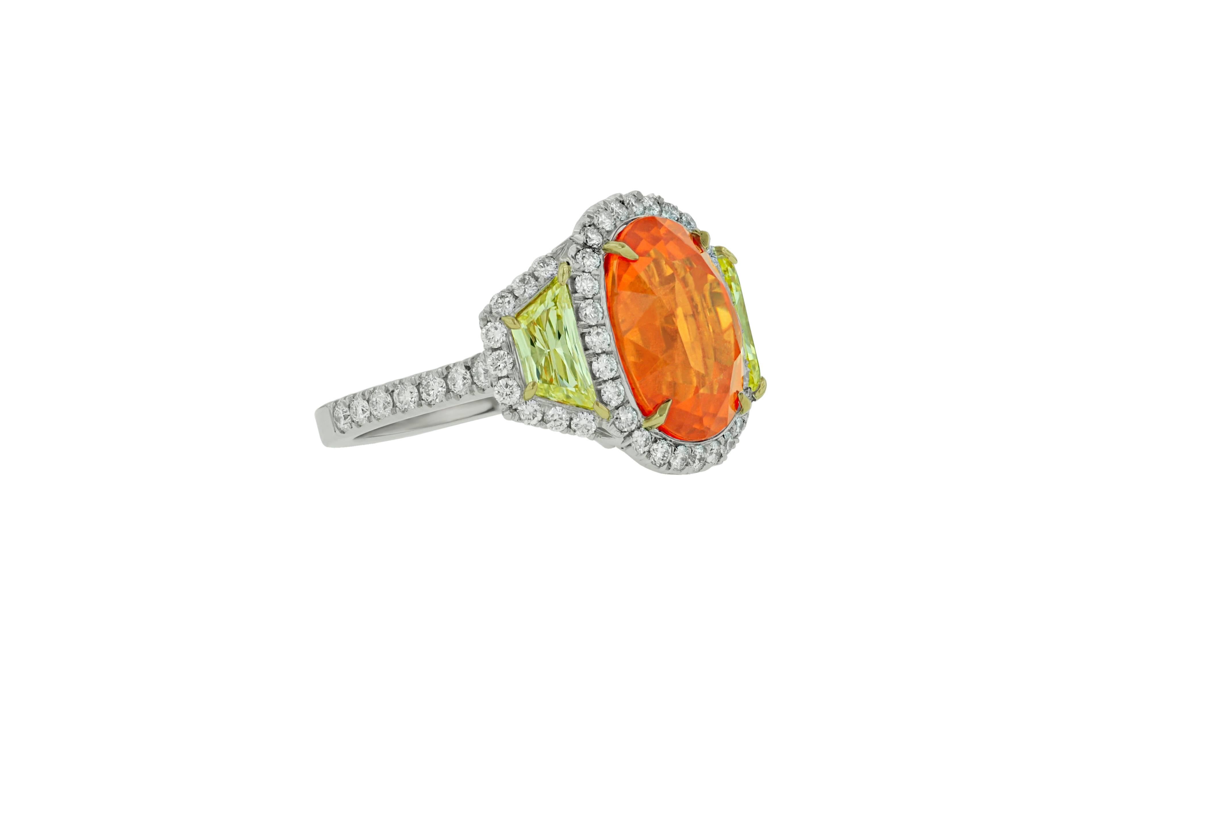 Platinum and 18KT custom designed Mandarin Garnet Ring, features finest quality mandarin garnet.
The center stone is 13.20 carats Oval shaped Mandarin Garnet, the highest color and quality of Garnet. 
Set with 1.50 Carats natural Fancy Yellow